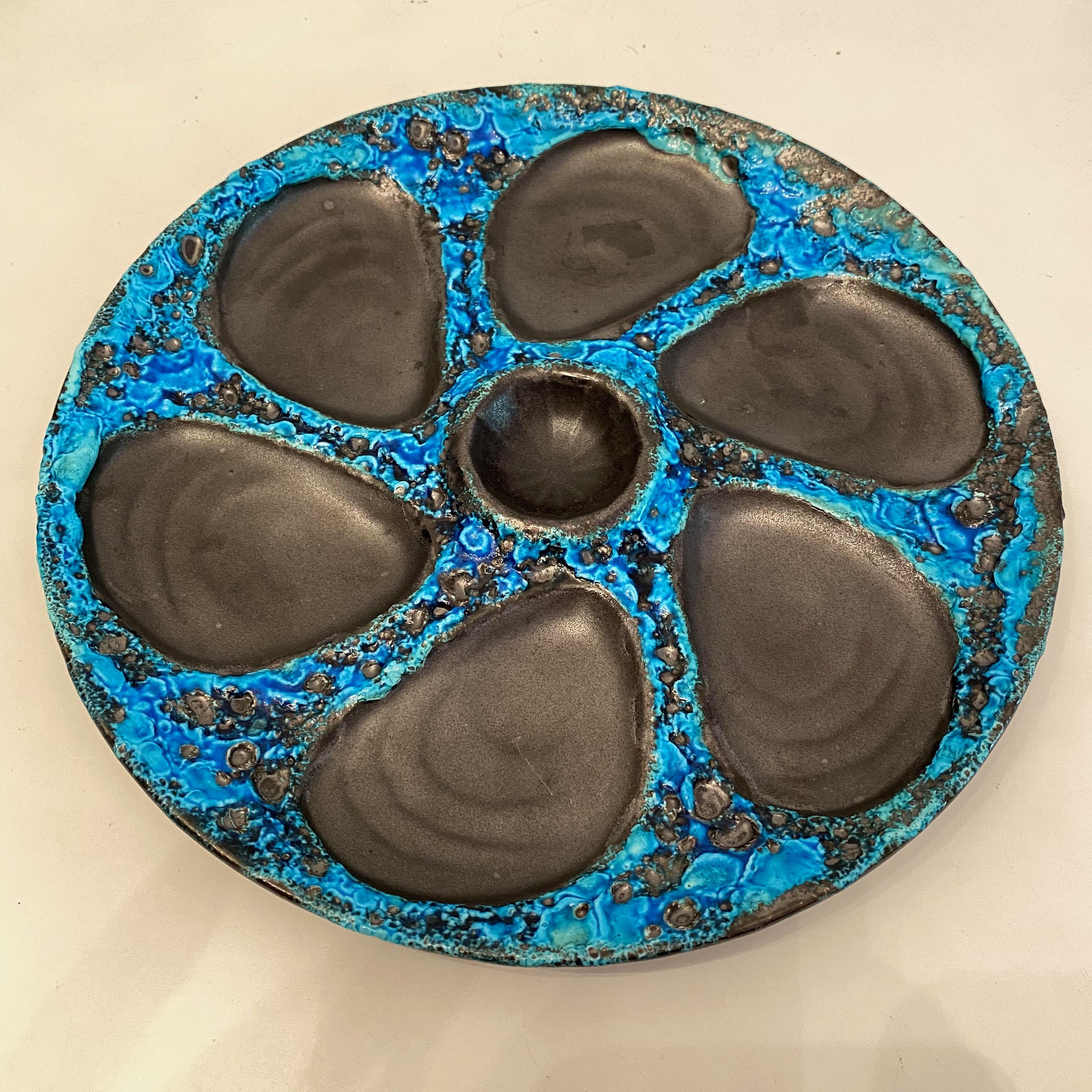 This beautiful oyster plate features 6 wells for oysters and one for the sauce or lemon. It is marked at the back with label. Nice addition to your table or just to display. It has no chips, cracks or repairs.
