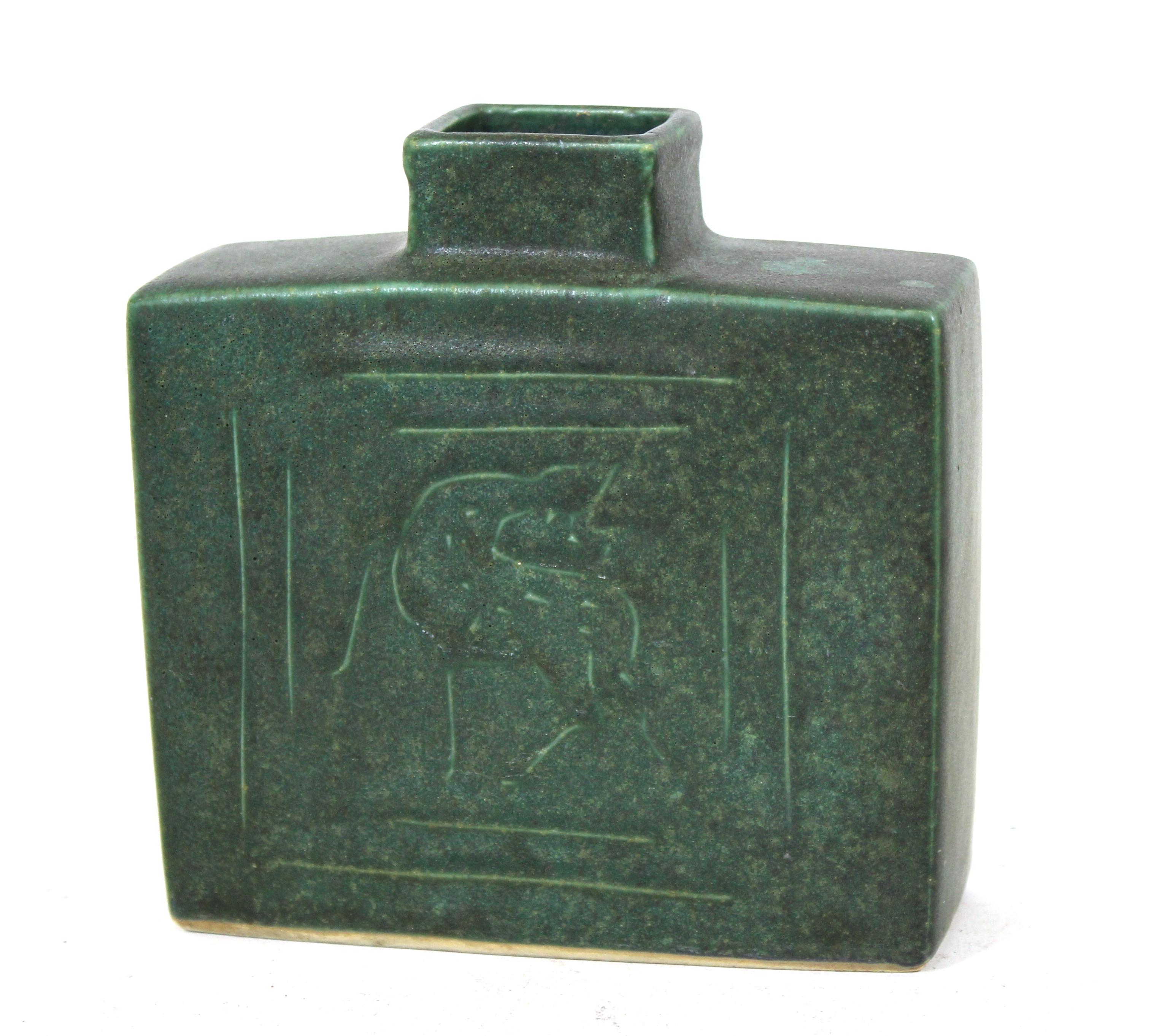 Mid-Century Modern rectangular shape pottery vase in green with stylized deer on the front and back side. Illegibly signed on bottom.