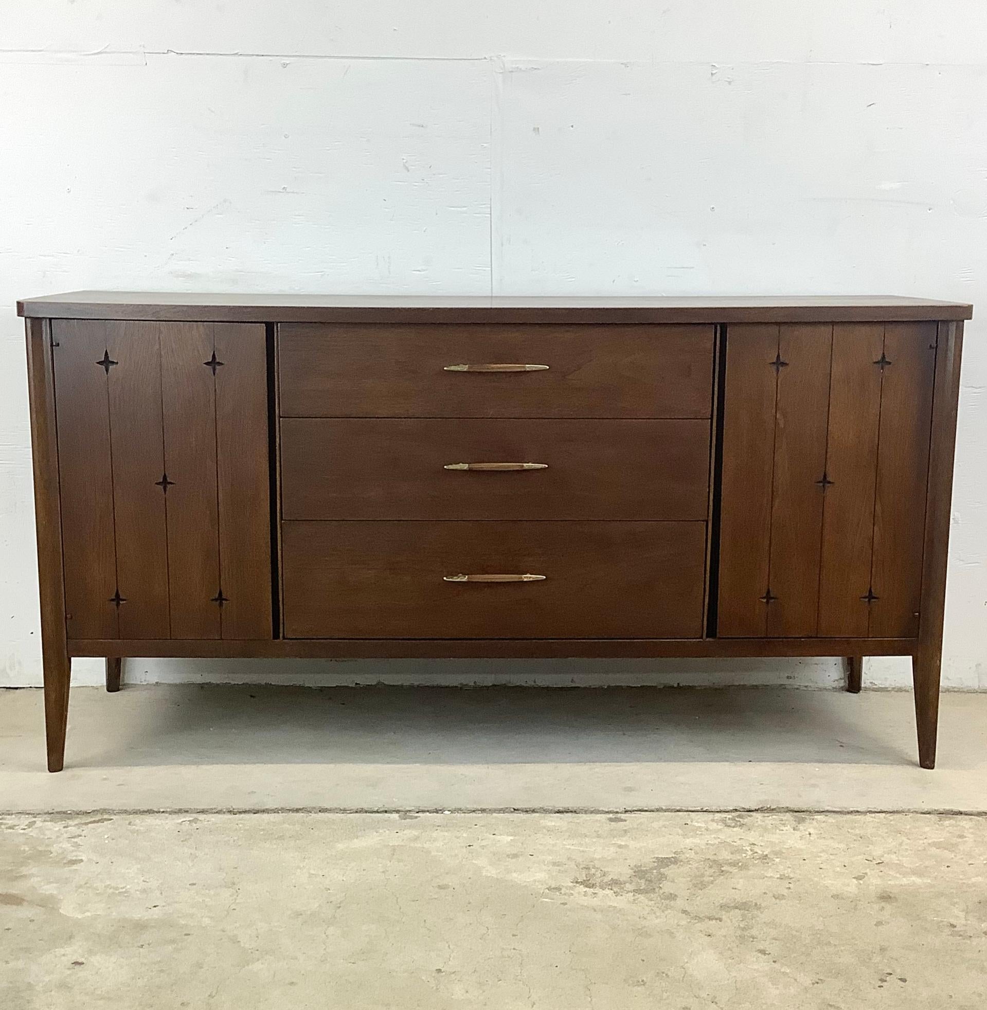 This Mid-Century Broyhill Premier Credenza is a timeless piece of furniture that brings both mcm style and optimal functionality to your home. Crafted with the quality craftsmanship and sleek design characteristic of Broyhill's Premier line, this