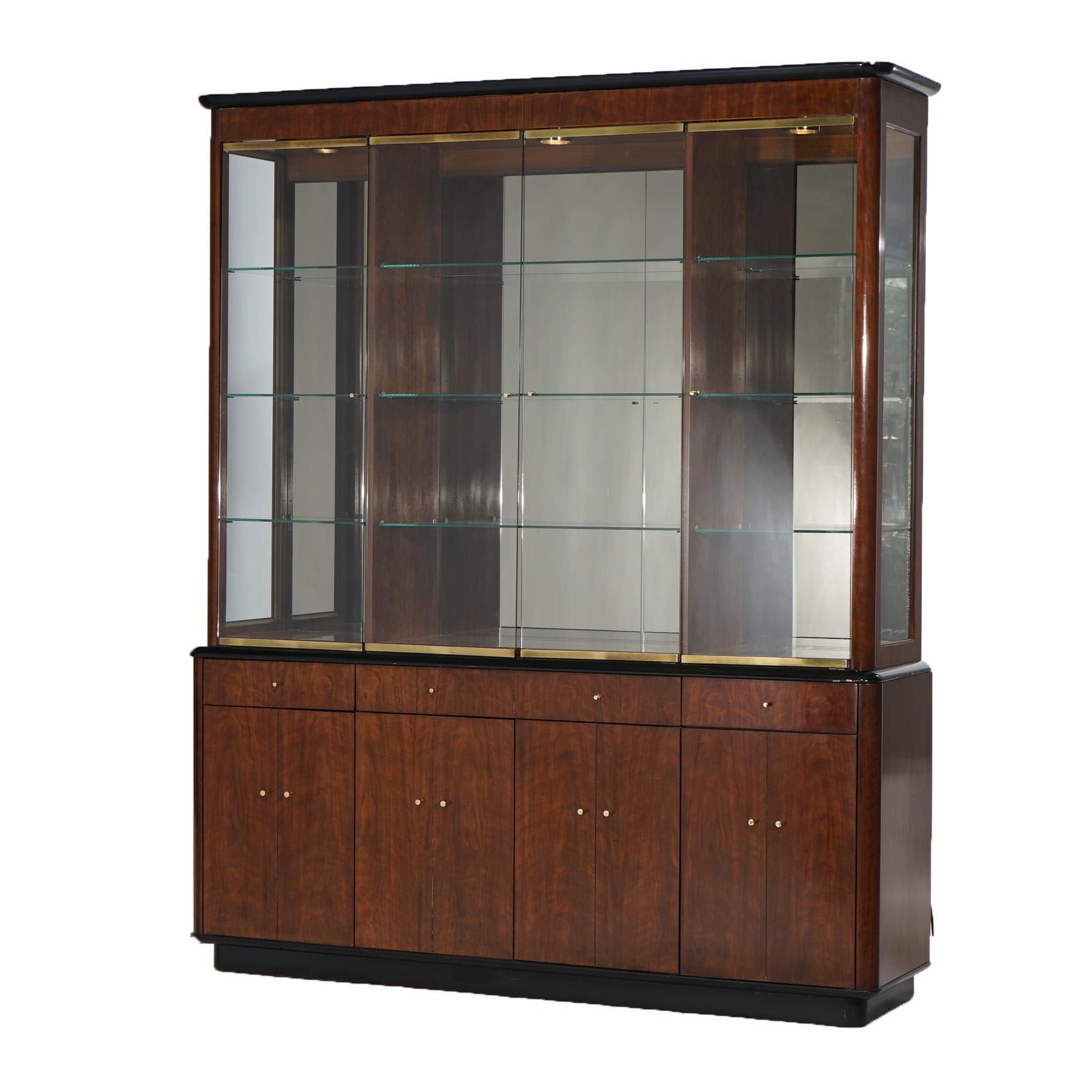 A Mid Century Modern breakfront cabinet by Drexel of the Profiles line offers glass upper over mahogany and ebonized cabinet base, maker label as photographed, 20thC

Measures- 80''H x 66.25''W x 16.25''D
