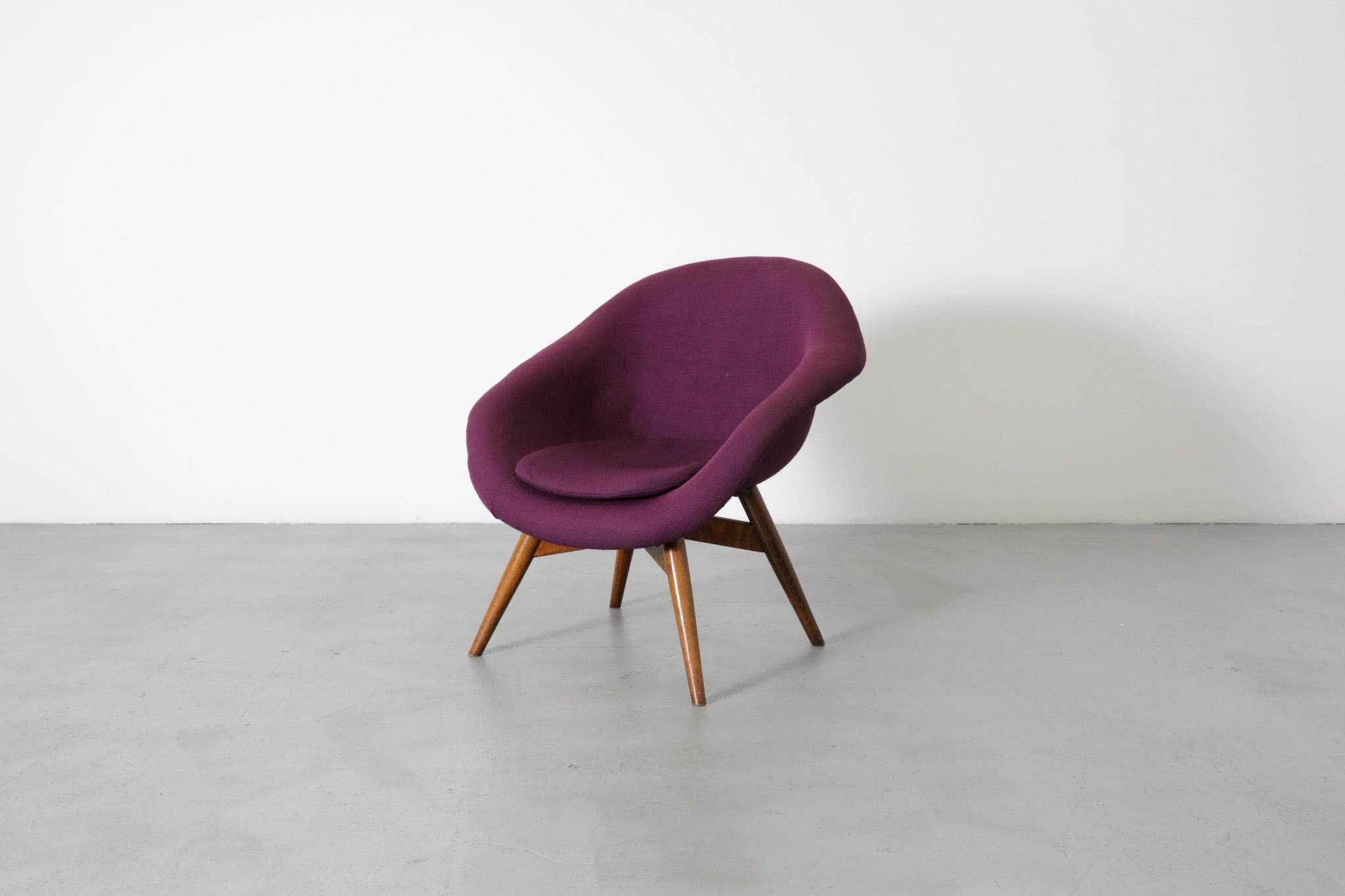 Newly upholstered purple Saarinen Style Mid-Century Modern bucket chair by Miroslav Navratil with dark stained legs. Frame is in original condition.