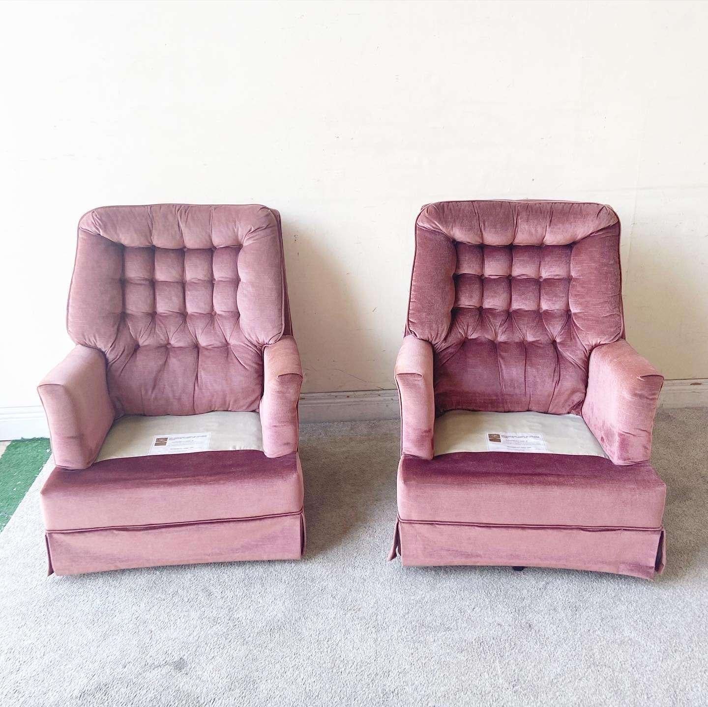 Exceptional vintage mid century modern swine lounge chairs. Each feature a purple fabric with tufted back rests.
