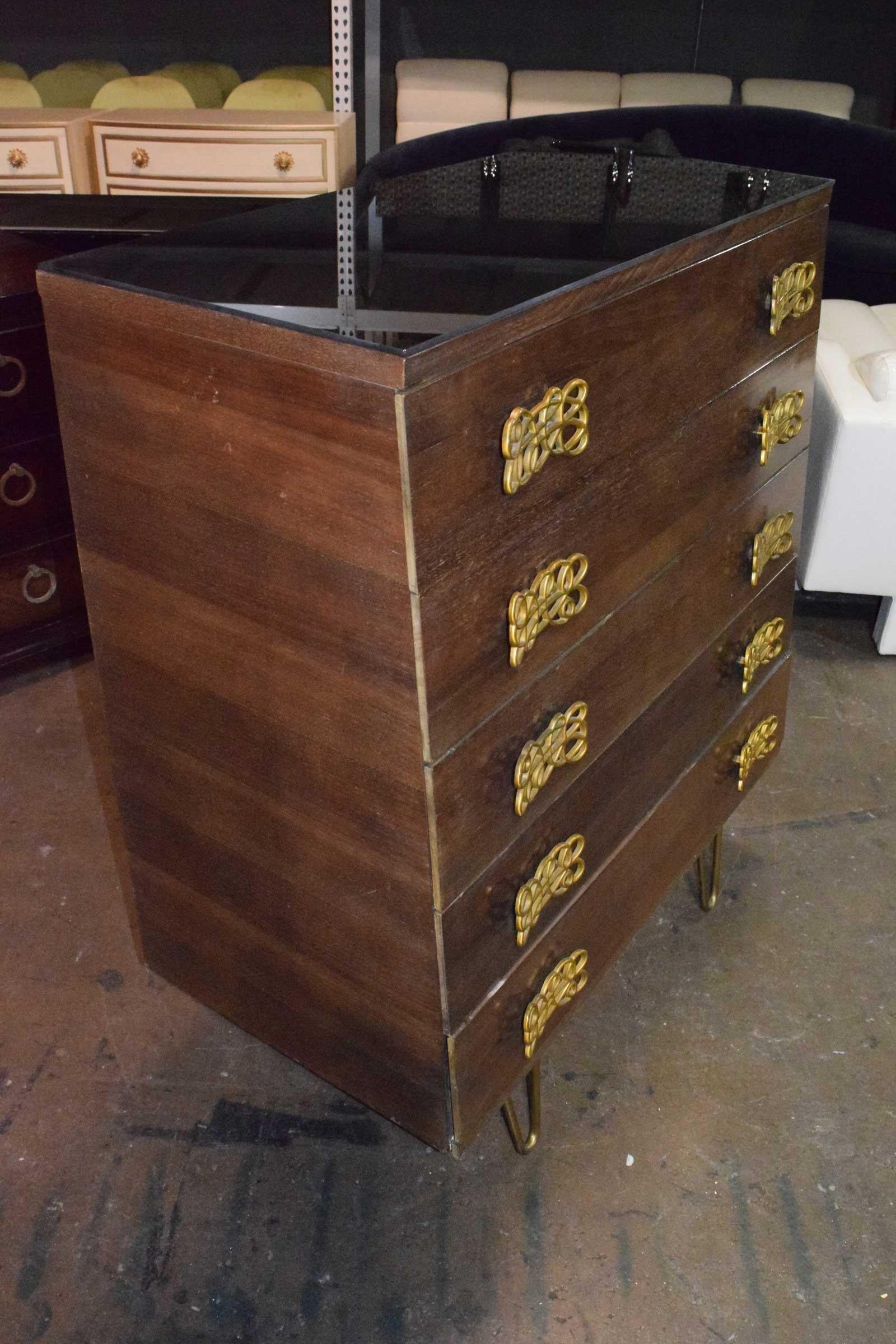 This is a beautiful chest of drawers with lots of interest. The shape displays sculptural interest and is larger on the bottom. The hardware is highly decorative. A protective smoked glass top is included. We also have the matching dresser which we