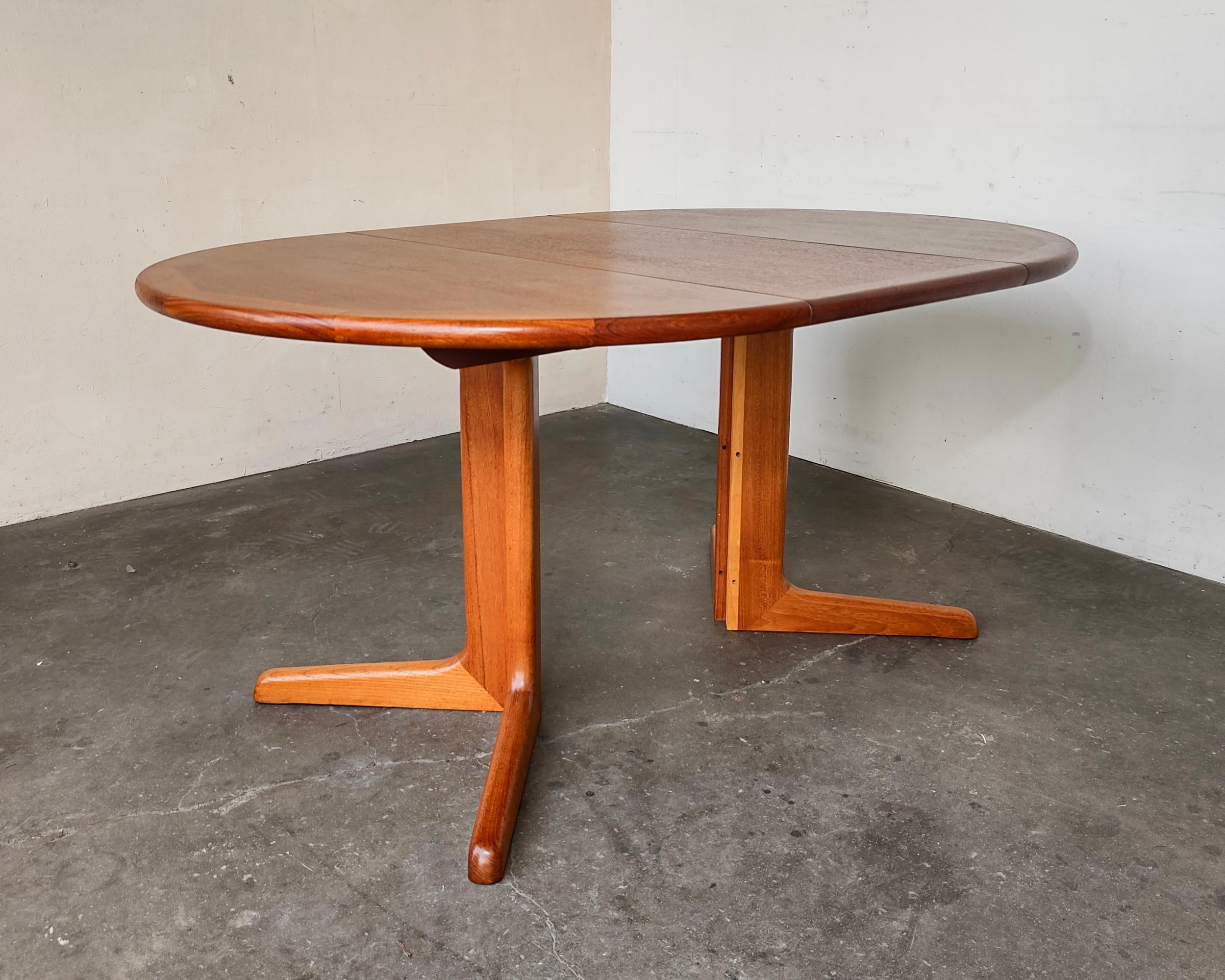 Mid-Century Modern teak extendable dining table. Classic Scandinavian design with rounded edge detail and joinery. Professionally restored with durable oil-based finish to showcase beautiful wood grain. Expands from round to racetrack shape. Overall