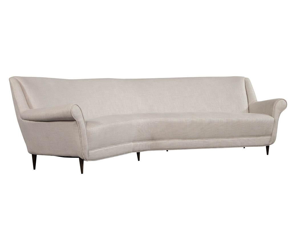 Unique and rare Italian Mid-Century Corner sofa. The curves make for architectural intrigue and can fit accordingly into niche rooms. The horizontal curves create the illusion of a wider space that is ideal for a small corner or alcove. This sofa