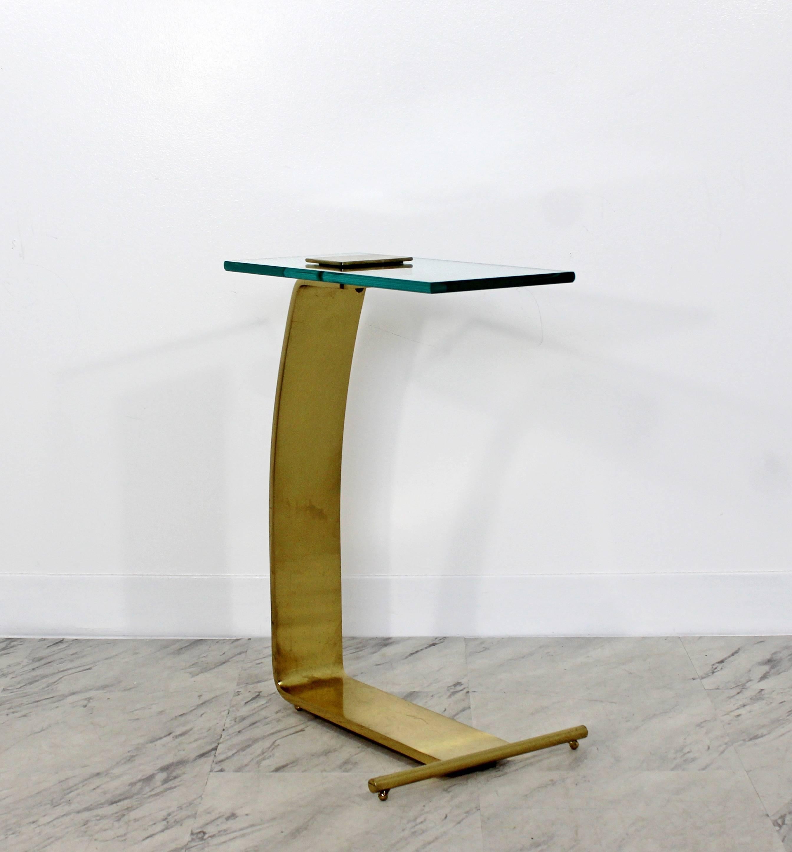 For your consideration is a fantastic, brass cantilevered side or end table, by The Design Institute of America, circa 1970s. In very good condition. The dimensions are 12