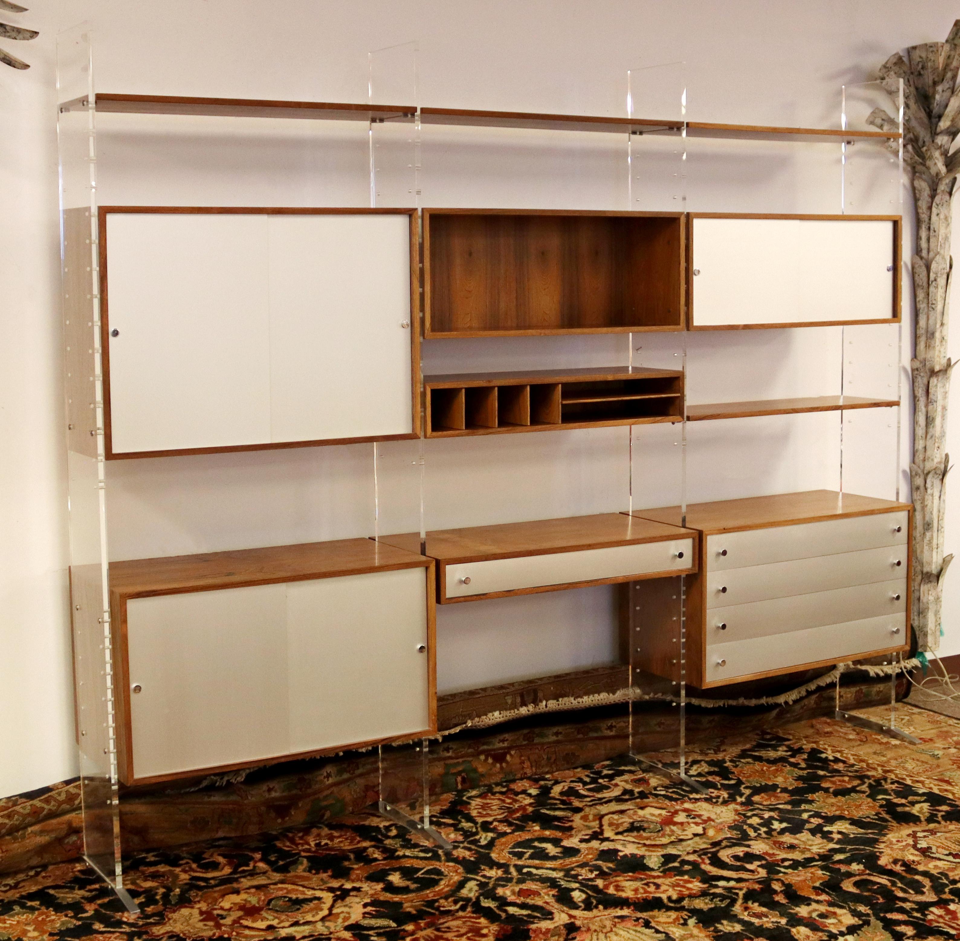 For your consideration is an utterly outstanding, three bay wall unit, with several compartments and shelfs, made of lucite and wood, by Georg Petersens, made in Denmark, circa the 1970s. In excellent vintage condition. The dimensions are 102