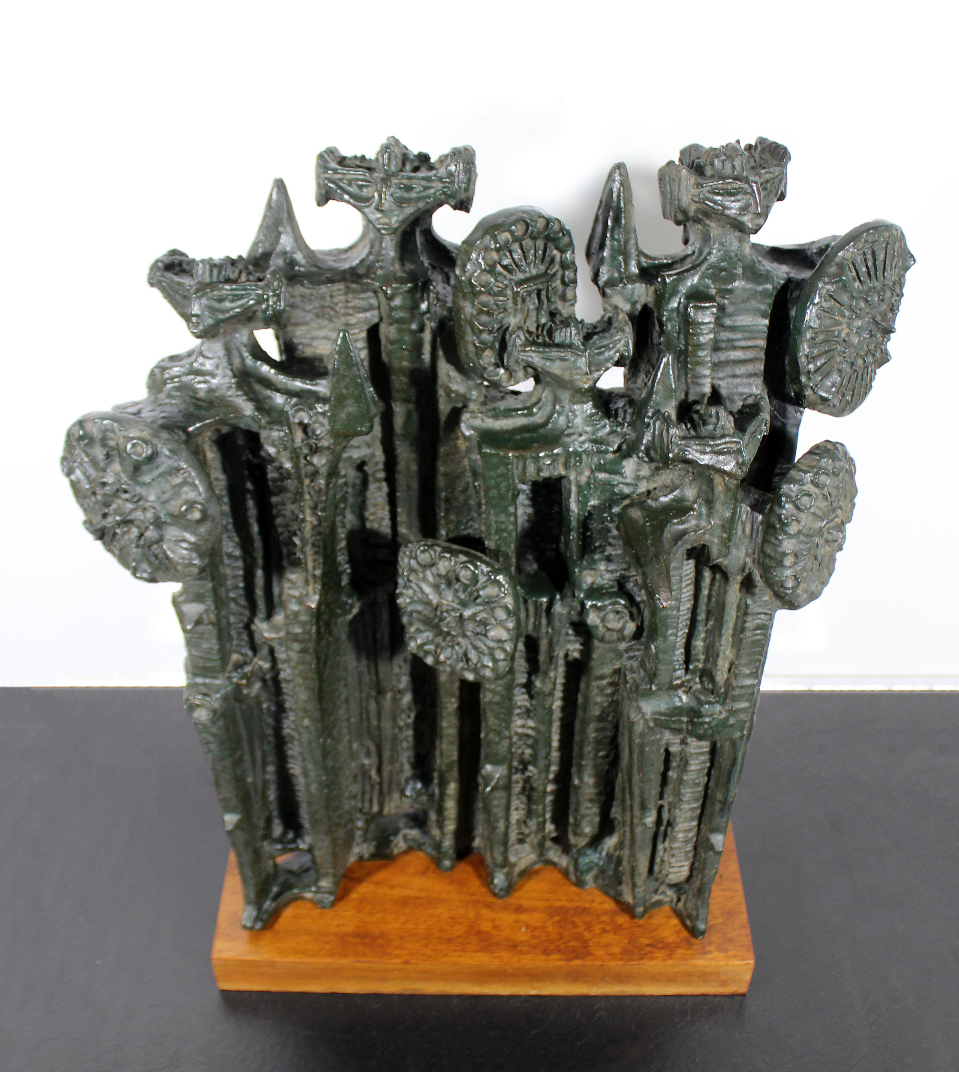 For your consideration is an incredible, Brutalist table sculpture, of abstracted figures, on a wood base, by Austin Productions, circa 1961. In excellent vintage condition. The dimensions are 20