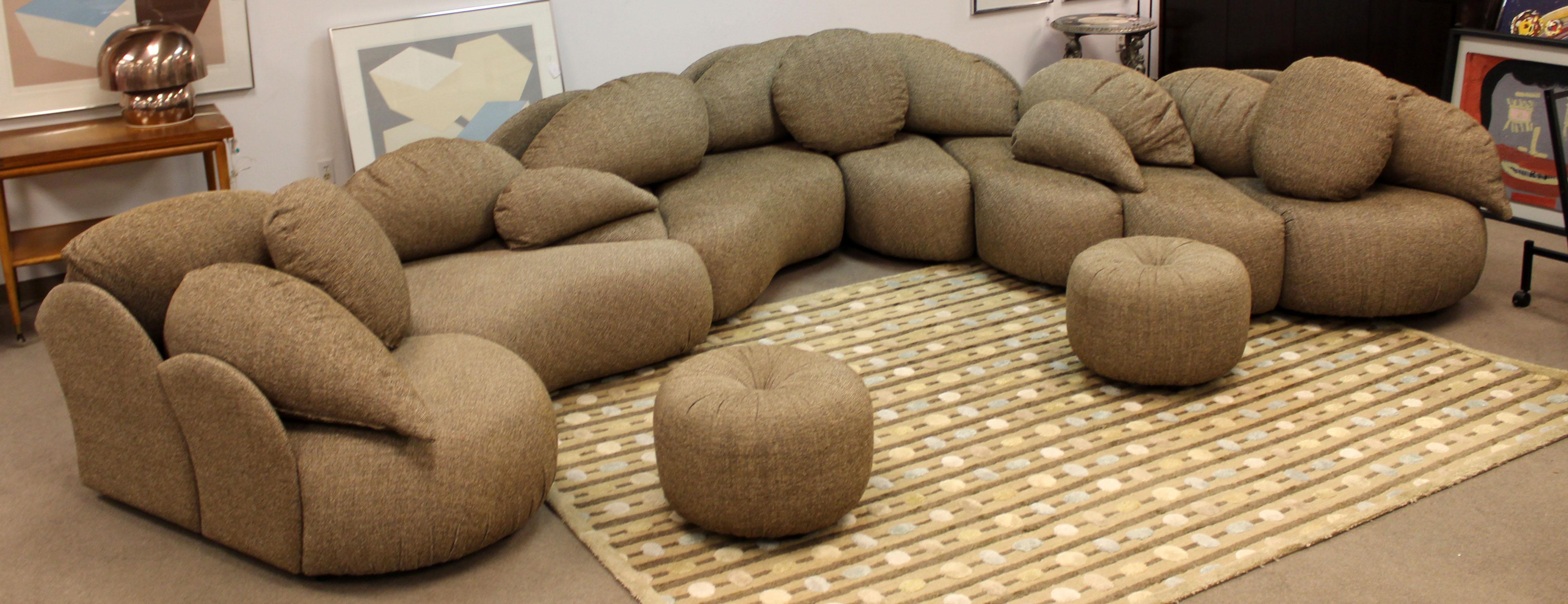 For your consideration is a wonderfully unique, large sectional sofa, with a sculptural design and two round ottomans, by Roche Bobois. Can be configured in any way to fit your needs. Extremely comfortable. Fabric and structure is in EXCELLENT
