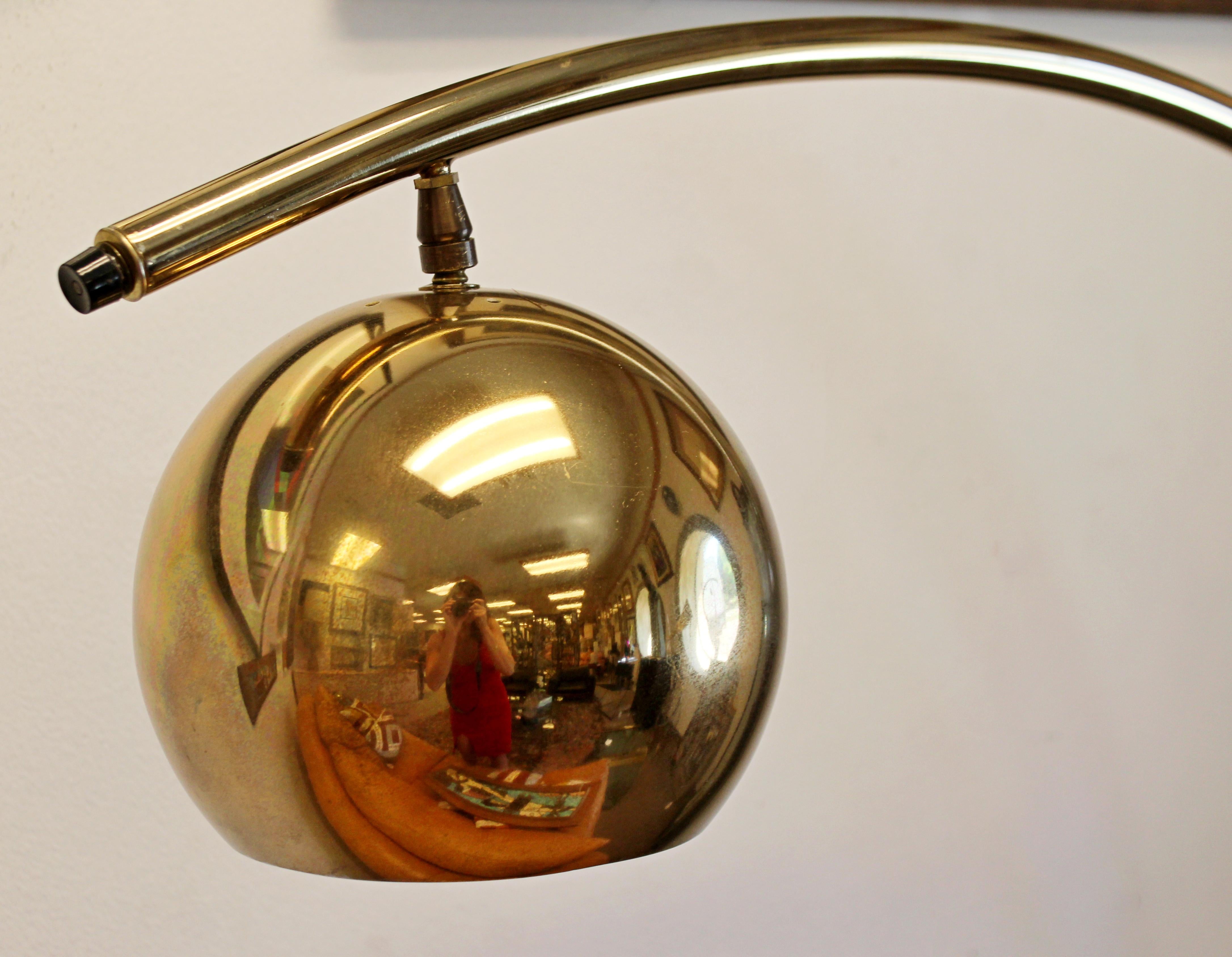 For your consideration is a subtle but magnificent, brass arc floor lamp, with adjustable head, by Robert Sonneman, circa 1970s. In excellent vintage condition. The dimensions are 8
