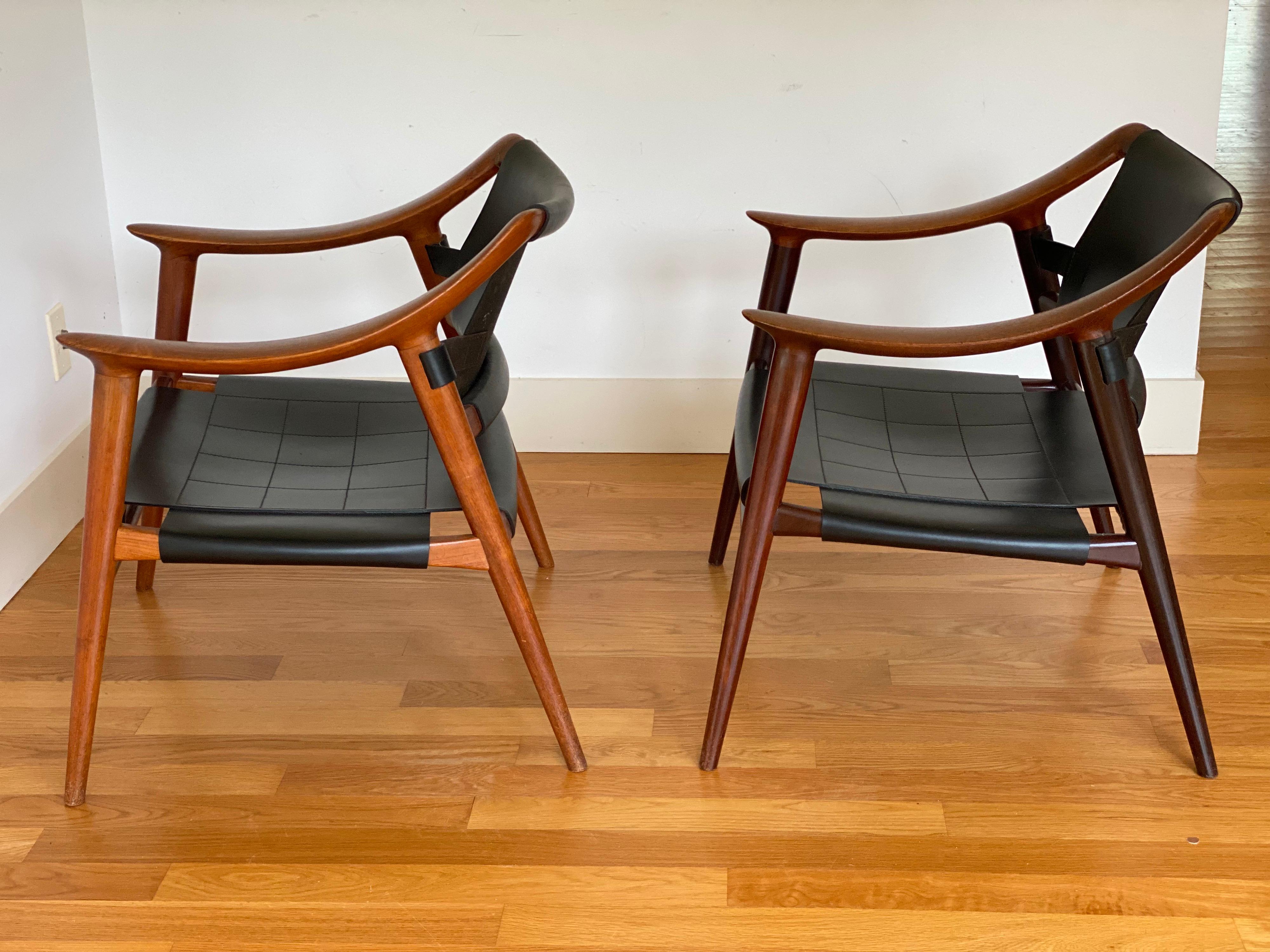 Rolf Rastad & Adolf Relling lounge chairs Model Bambi by Gustav Bahus in Norway.
Two available. Both made of teak and leather, however, one lighter due to sun fading. 
The smooth flat curved arms make these chairs both comfortable and a work of art.