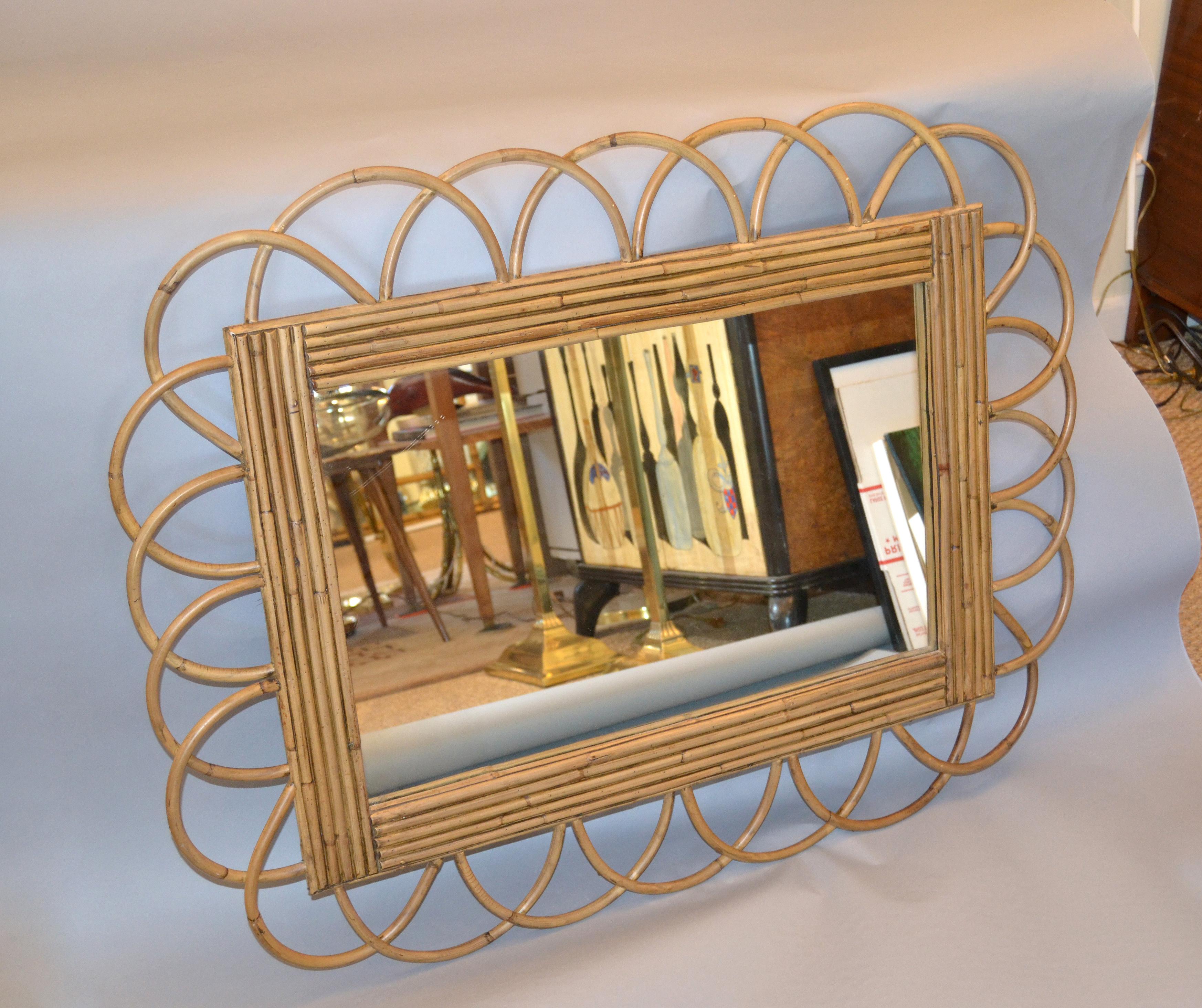 Mid-Century Modern Rattan, bamboo and pencil reed wall mirror from the late 1950s.
Can be hung horizontal as well as vertical.
 