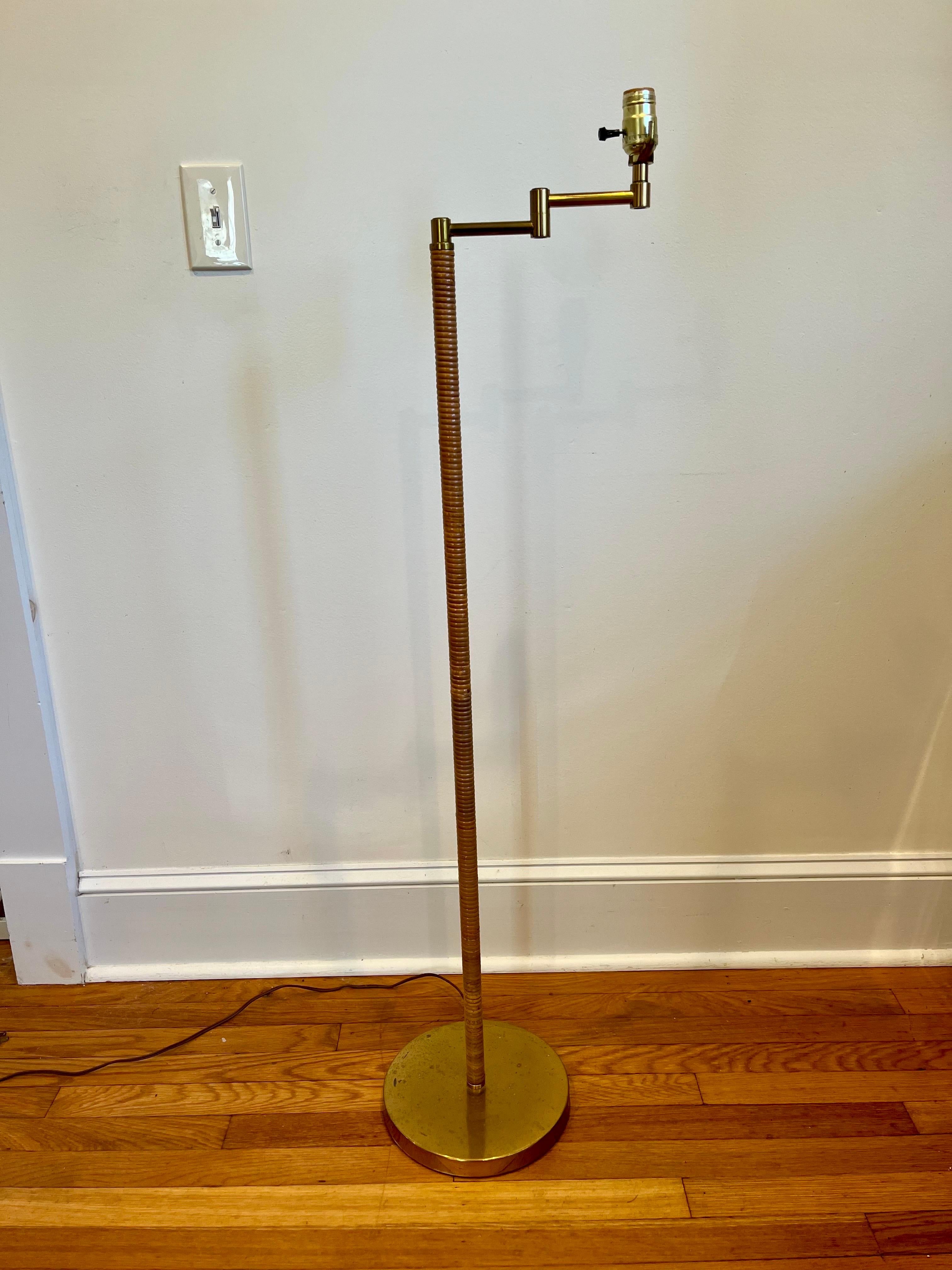 A Mid-Century Modern Transitional vintage wrapped rattan and brass floor lamp. Swing arm brass fixture. 15