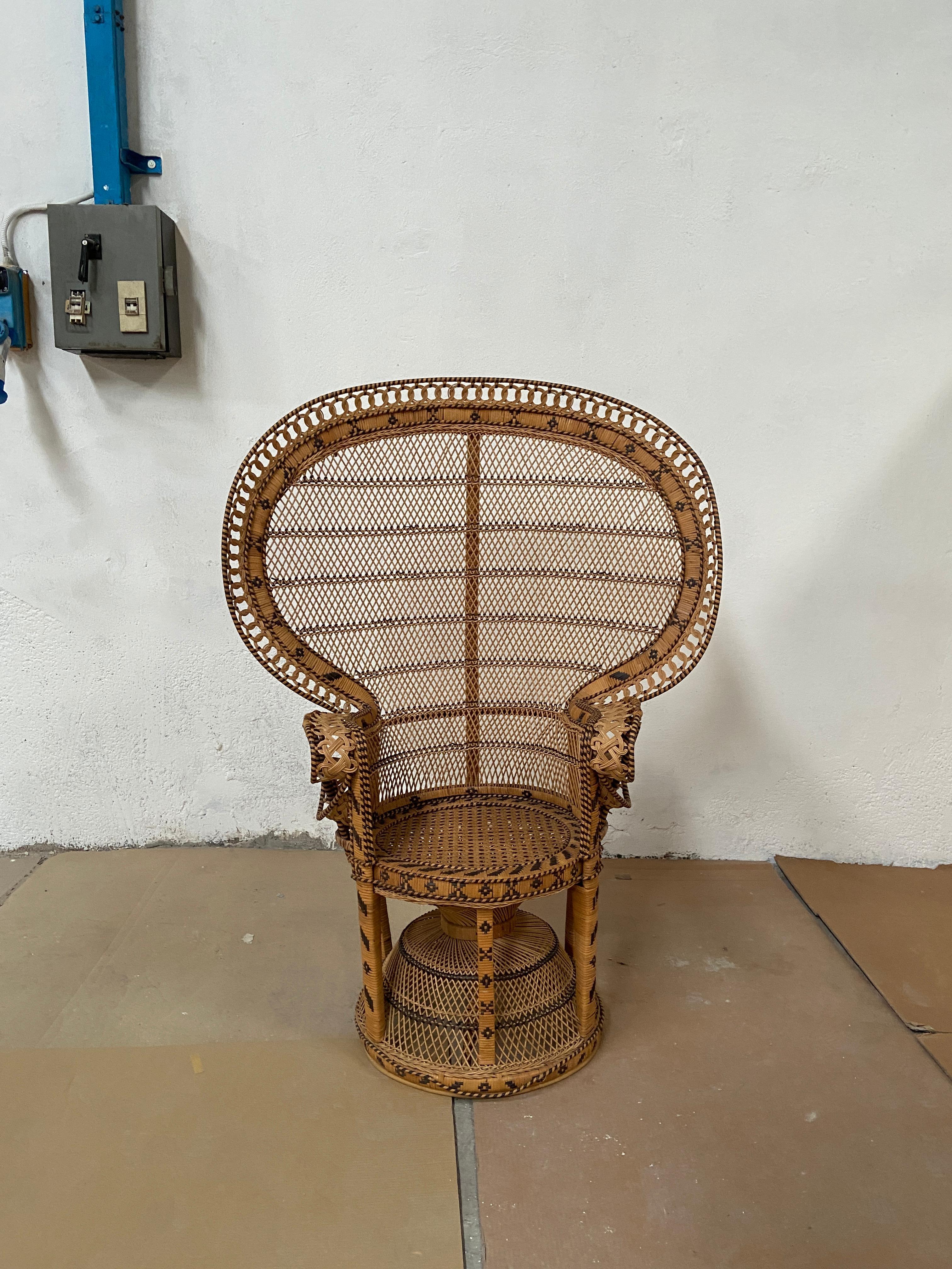 A two-tone Indonesian peacock chair made out of bamboo and rattan. 
This chair became iconic since it was an eyecatcher in the famous ‘Emanuelle’ movie. 
The chair is in a very good original condition.