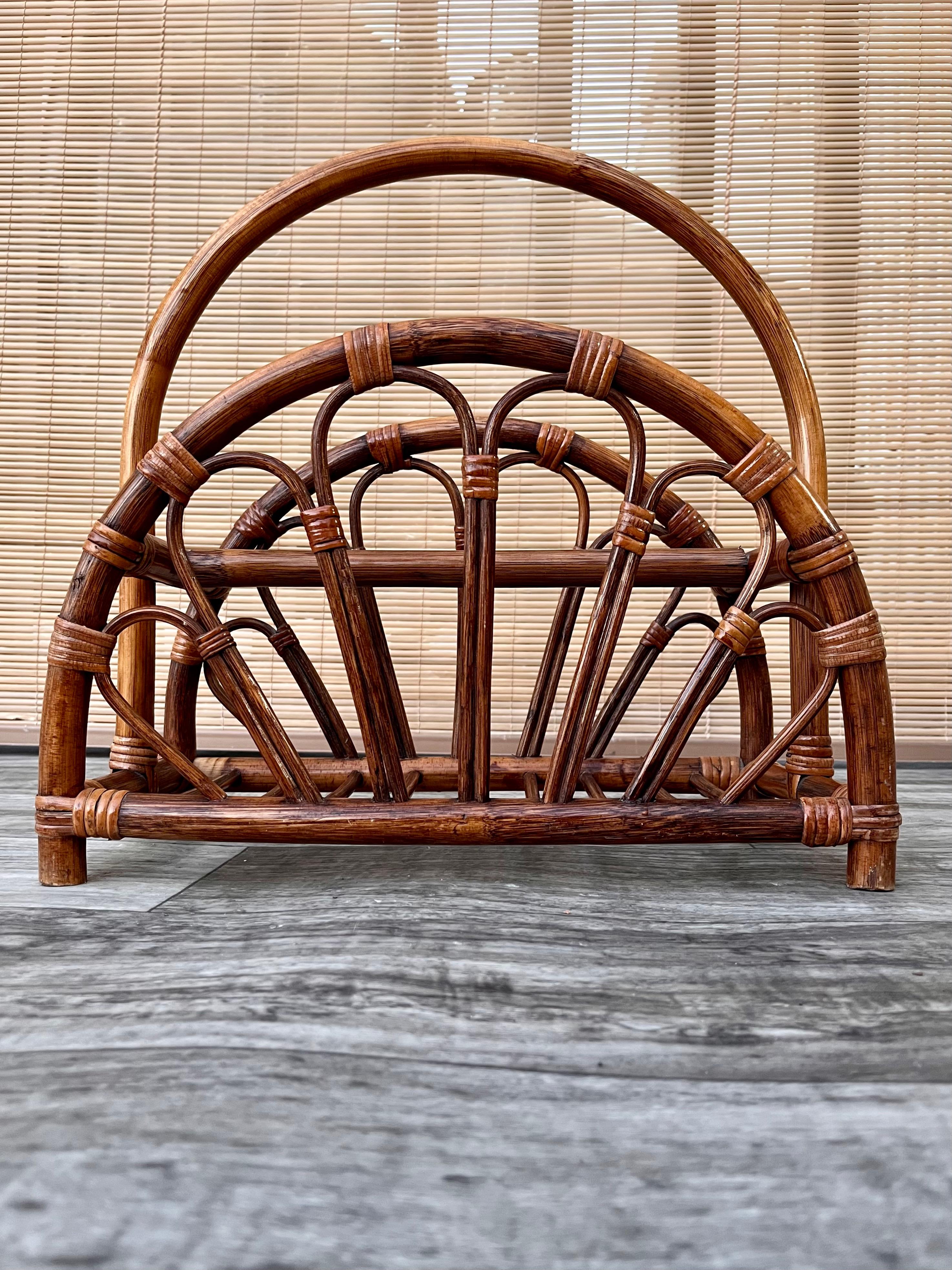 Vintage Mid-Century Modern Rattan bamboo magazine rack in the Style of Franco Albini. Circa 1970s.
Features an arched rattan frame designed in the style of Franco Albini & McGuire, and Ficks Reed. 
In excellent original condition with minor signs