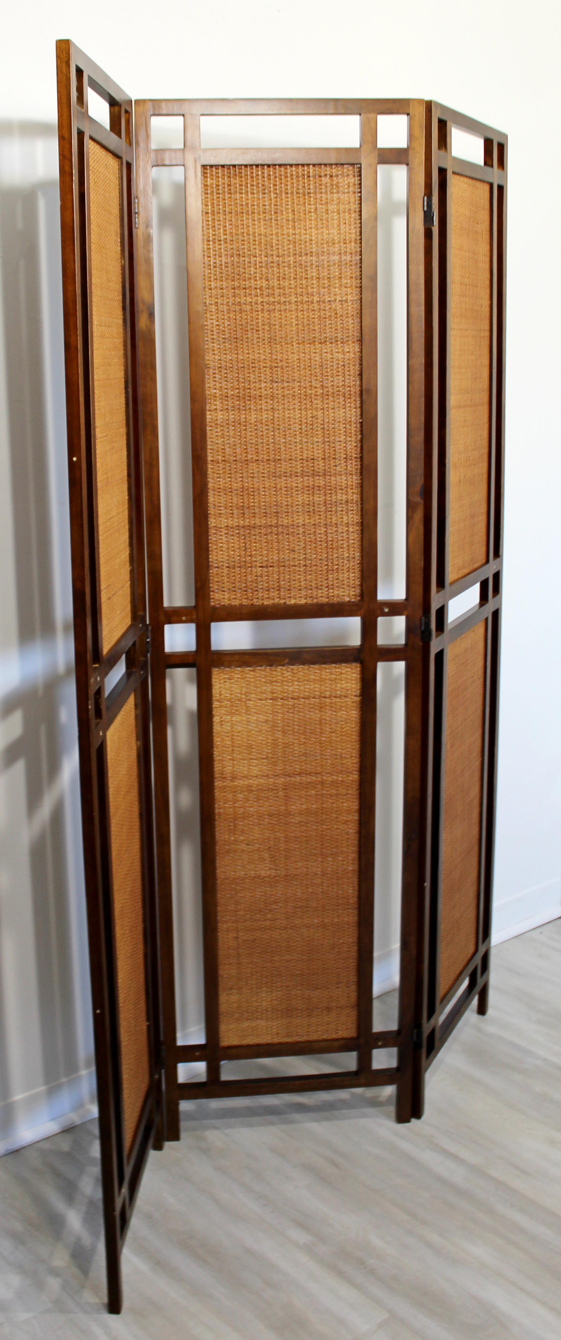 For your consideration is a gorgeous, three panel, free standing room divider screen, made of walnut wood and rattan, circa the 1960s. In very good vintage condition. The dimensions are 70