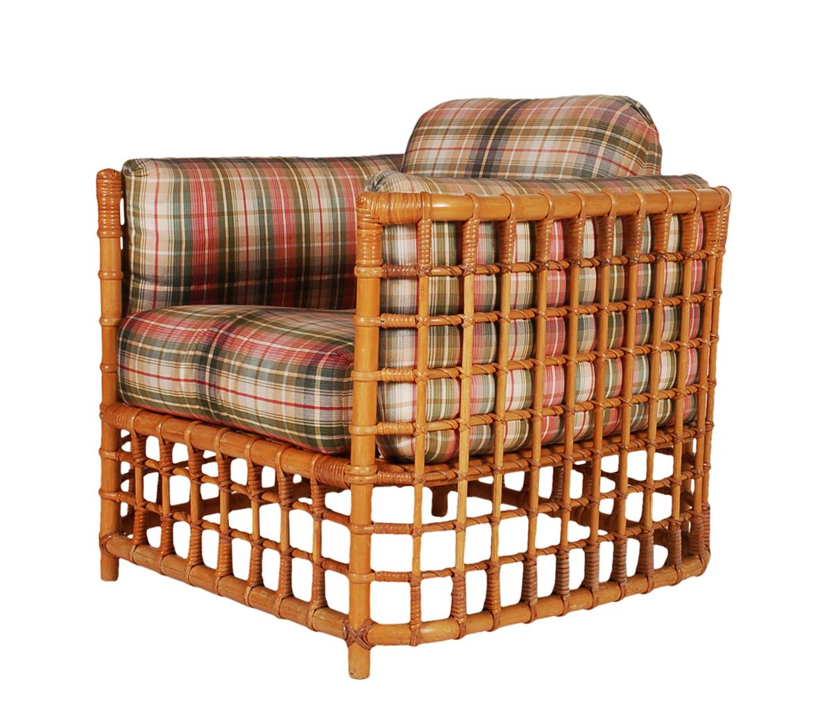 A handsome and tropically modern club chair and ottoman, circa 1970s. This was designed by Henry Olko and produced by Willow & Reed. It features handmade rattan construction with cushions. Ottoman measures: W 24, D 23, H 18.