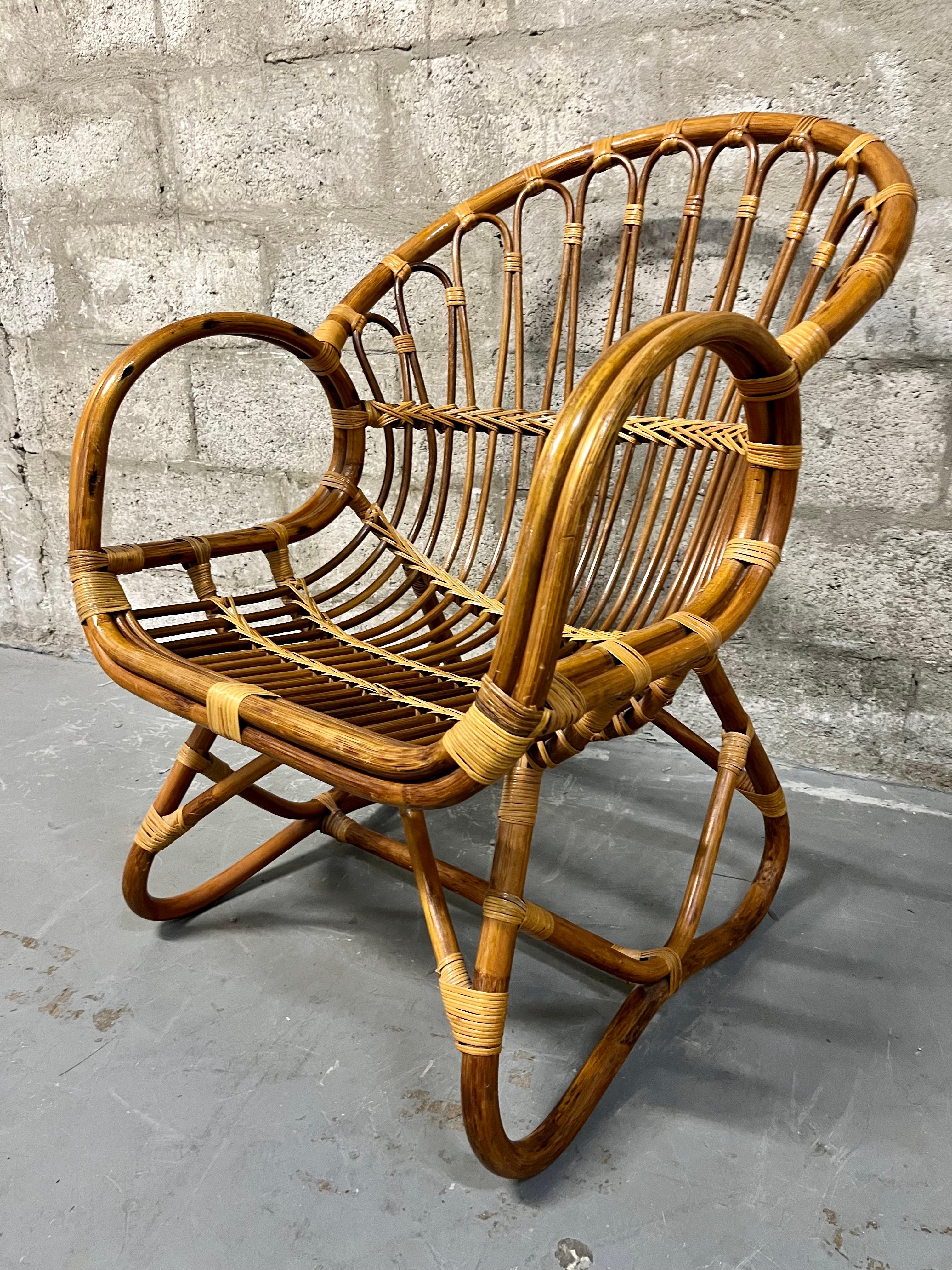 Mid Century Modern / Boho Chic Style Rattan Lounge Chair in the Franco Albini Manner. Circa 1960s
Features a sophisticated design with rounded armrests, backrest and legs, and intricate braiding details. 
In excellent original condition with very