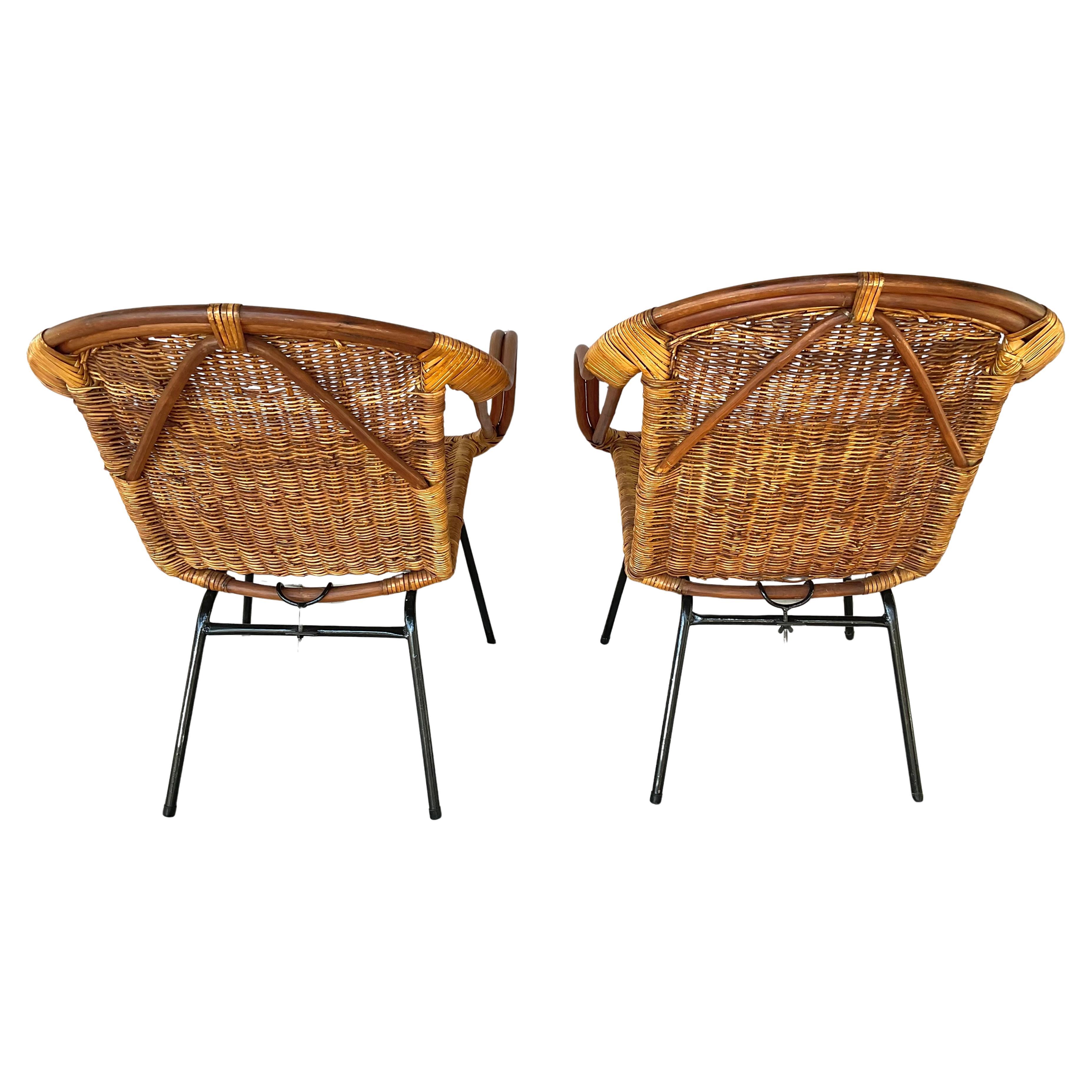 Mid-Century 20th Italian Rattan and Metal Armchairs. Chairs feature handwoven rattan seats and backs, framed by curved wooden arms and supported by sleek black metal legs, typical or the mid-century modern design. Chairs are in great condition,