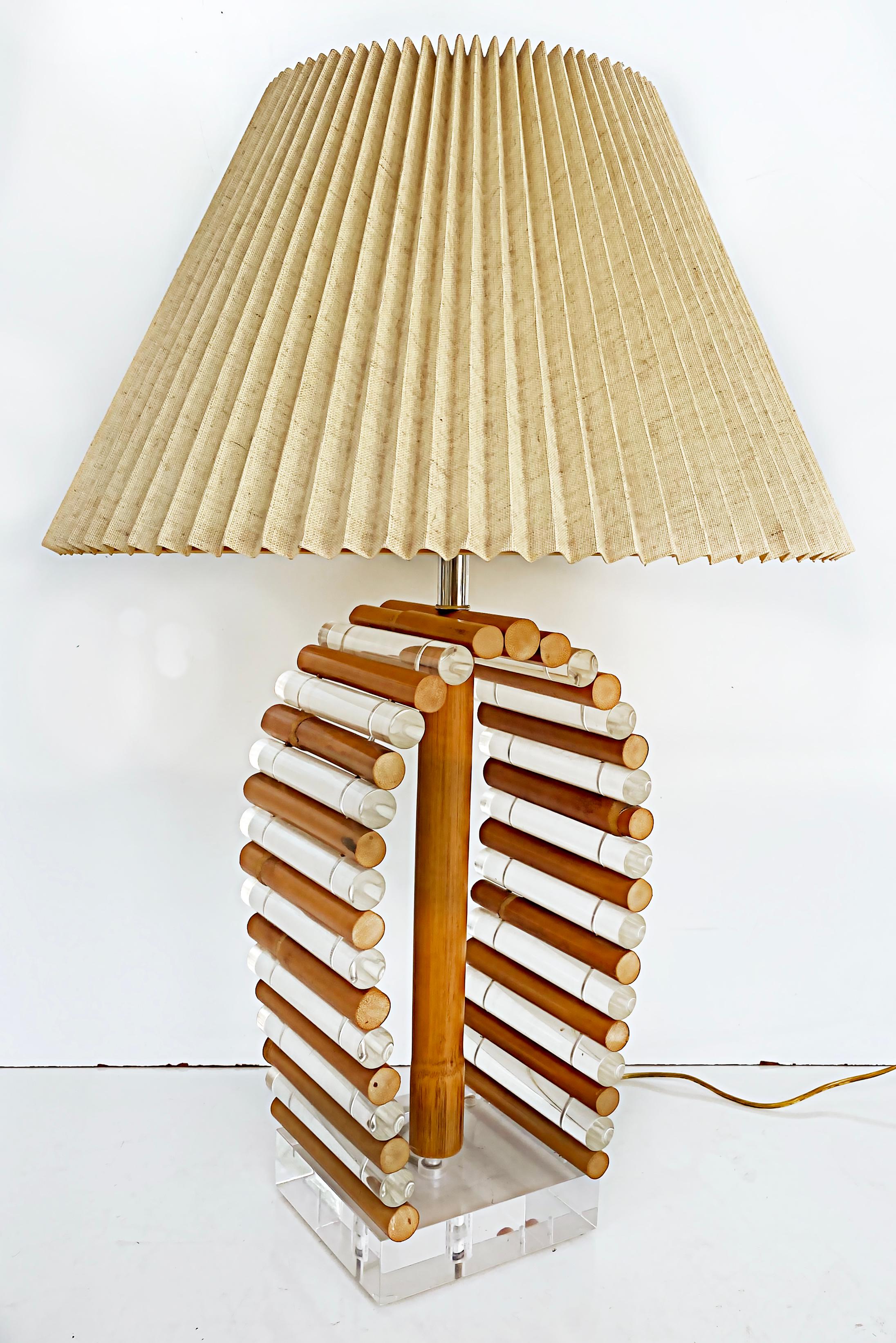 Mid-Century Modern Rattan Lucite table lamp with original finial

Offered for sale is a Mid-Century Modern rattan and Lucite table lamp with the original Lucite finial. The original wiring is in good working condition. This lamp has a single socket