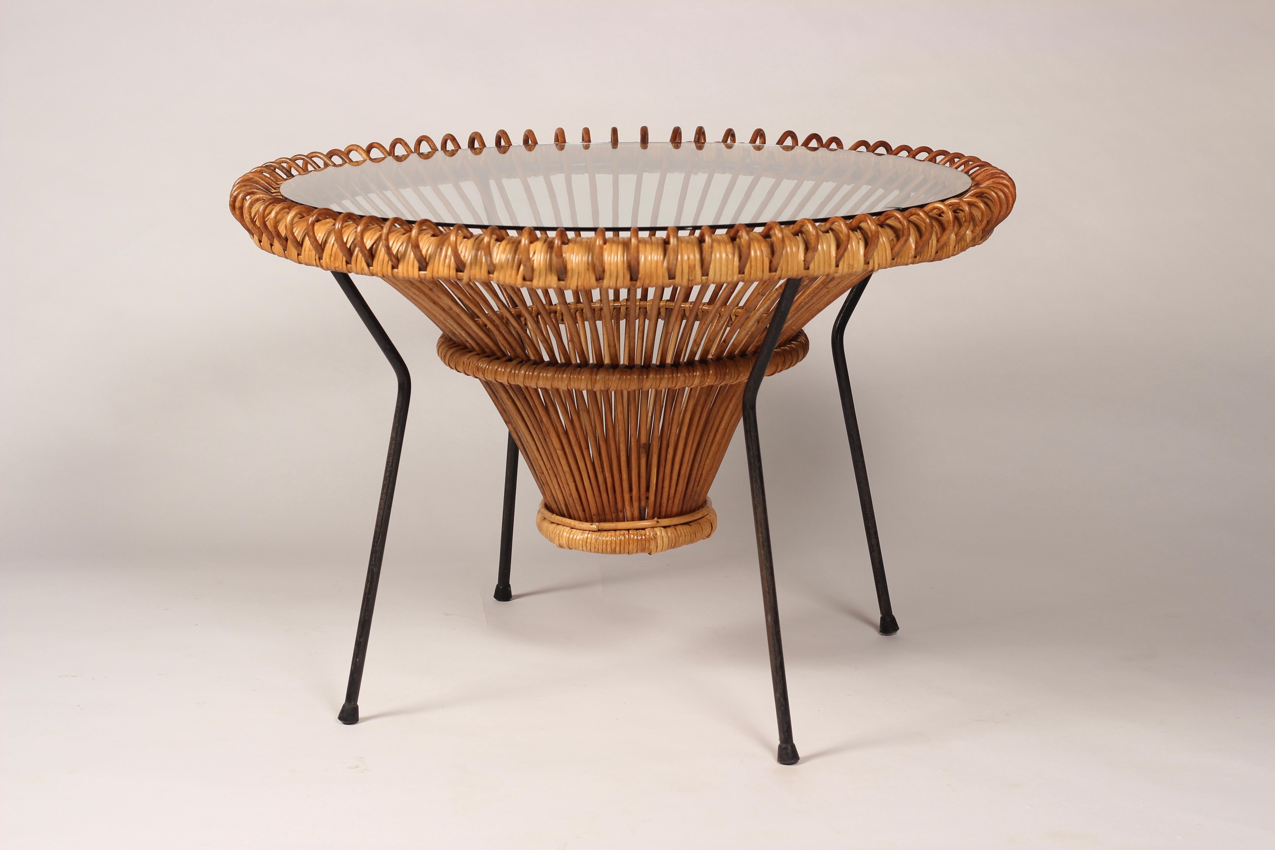 A good example of a Mid-Century Modern side table/coffee table in the style of Franco Albini

A 1950’s wicker rattan table, which has a visual lightness of structure and weight. It works particularly well in not filling a space with solid volume,