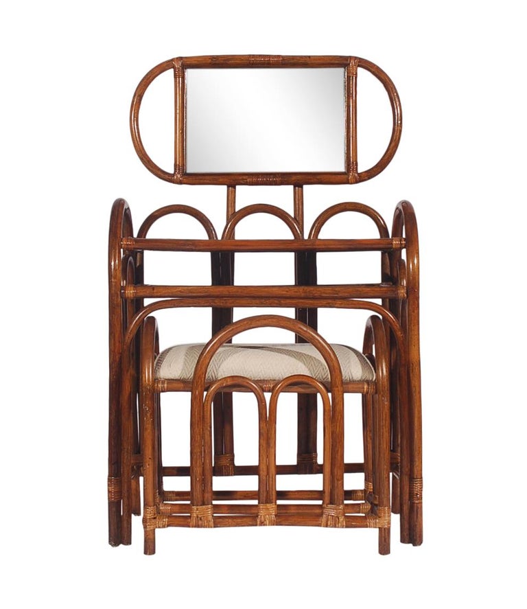 A funky rattan set with a nod to the Art Deco period from the 1970s. It features bent rattan construction, with mirror and upholstered stool. Price includes set as shown.