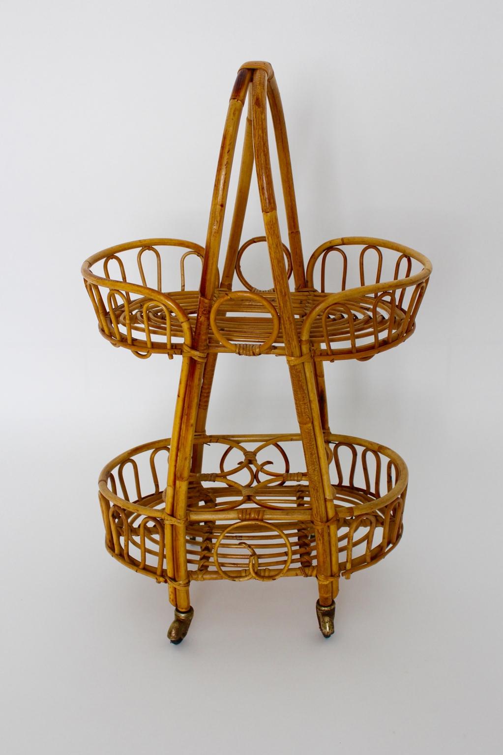 Mid Century Modern Vintage bar cart wheel supported from rattan 1950s Italy.
This presented cute rattan vintage bar cart from the 1950s was designed and made in Italy.
Furthermore the bar cart is usable not only for bottles and beverages also to