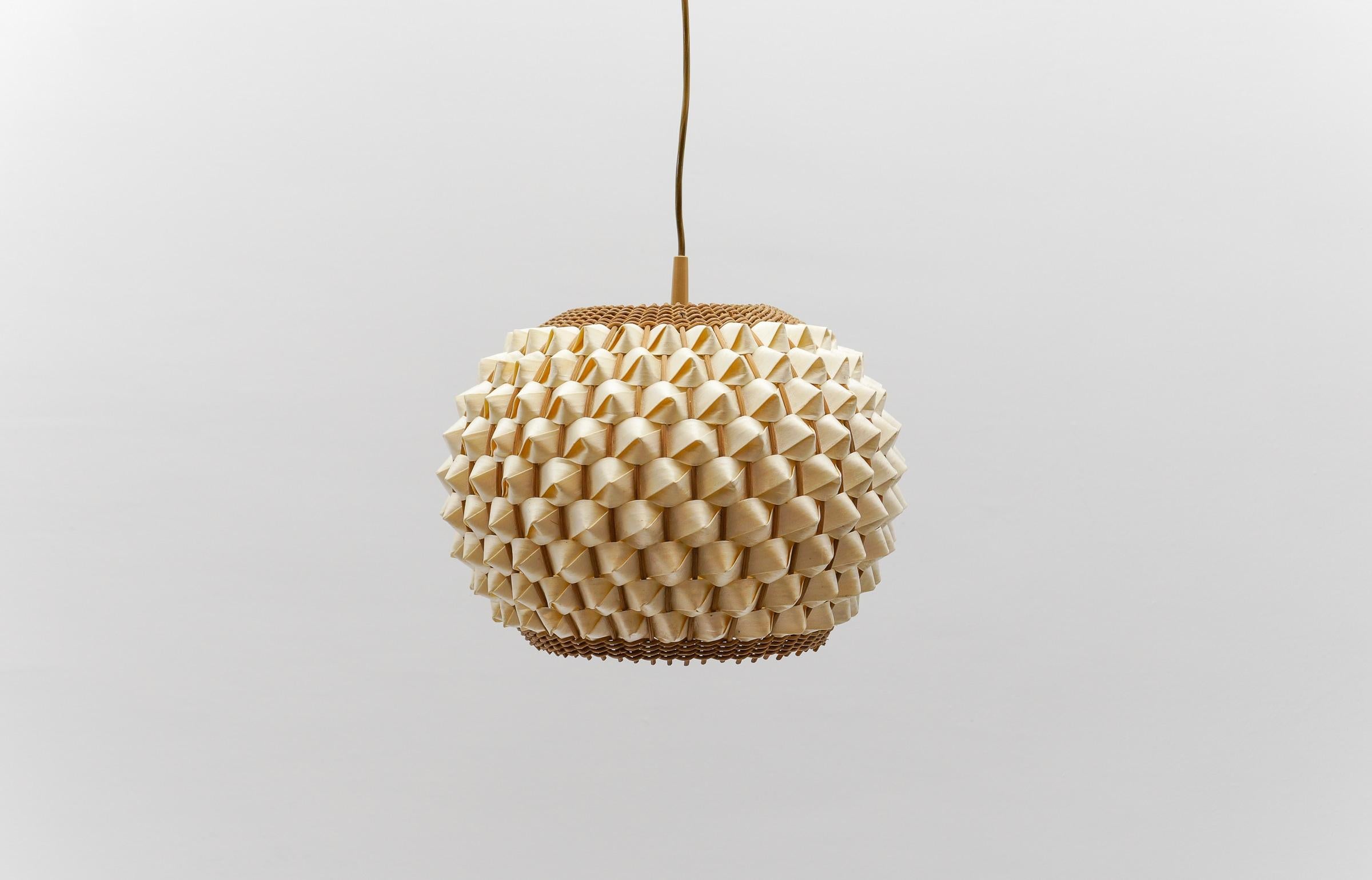 Seltene und schöne dekorative Mid-Century Modern Pendelleuchte. Entworfen und hergestellt wahrscheinlich in Italien, 1960er Jahre.

Die Lampe kann bis zu 45 cm hoch verstellt werden.

Die aus Rattan und Holz gefertigte Pendelleuchte wird mit 1 x E27