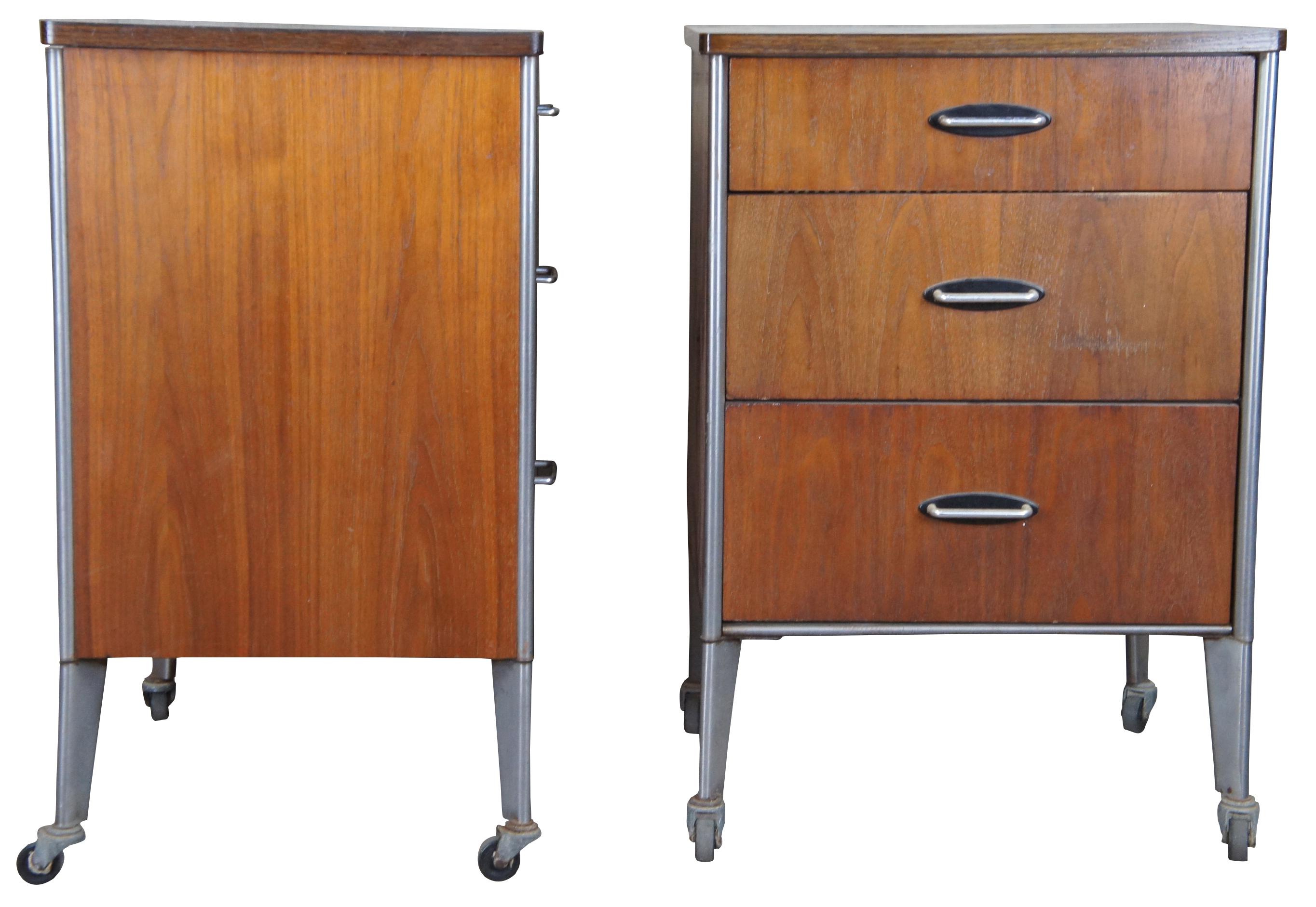 Vintage Mid-Century Modern Roymond Loewy Hill-Rom consoles or cabinets. Made of aluminum and walnut featuring three drawers and rolling swivel casters. Hill Rom was a branch of Romweber Furniture.
   