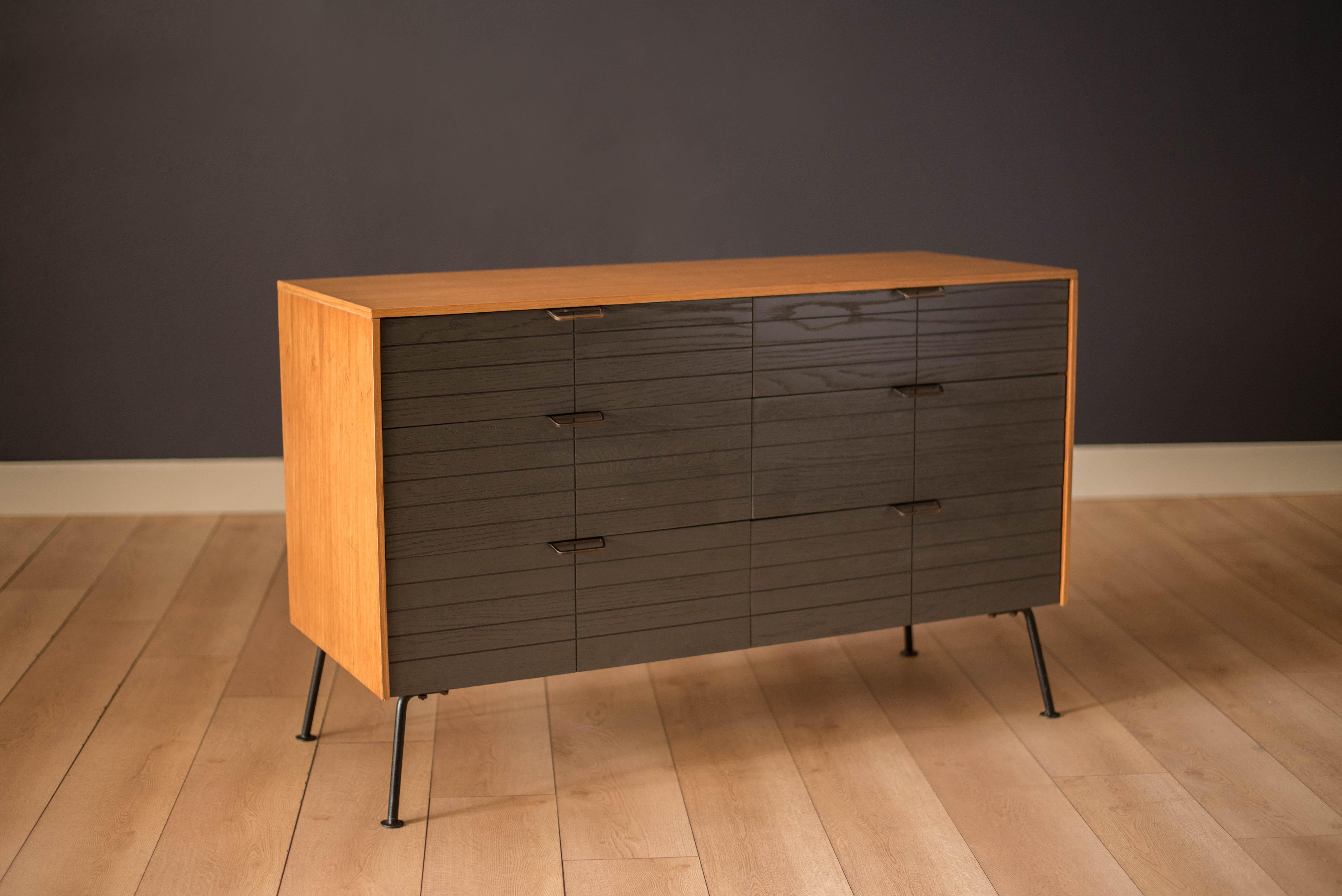 Vintage double dresser in natural white oak designed by Raymond Loewy for Mengel Furniture Co., circa 1950s. Features a two-tone case accessorized with signature metal hardware and iron legs. This piece includes six dovetailed drawers in a bold gray