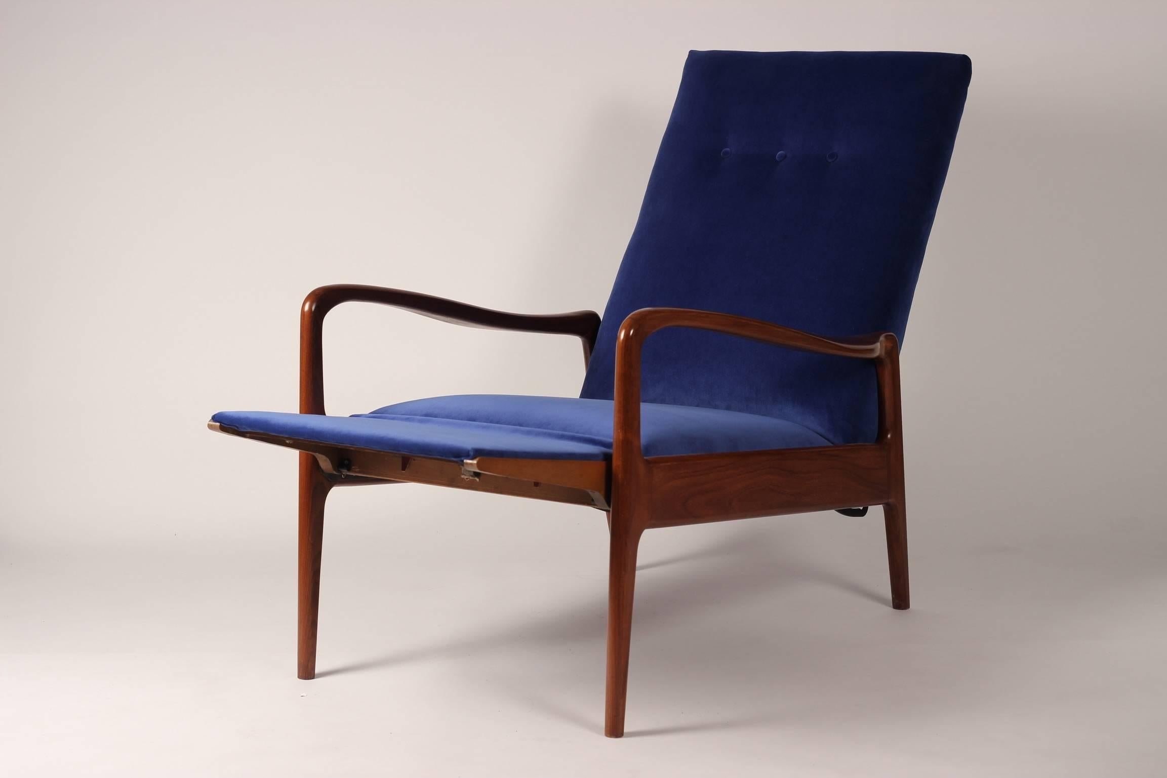 A British-made and designed reclining lounge chair by Greaves and Thomas of Mayfair produced, circa 1960s. With beautiful curved solid Afrormosia (African Teak) arms and angled legs, this chair has recently been reupholstered in an Italian velvet.