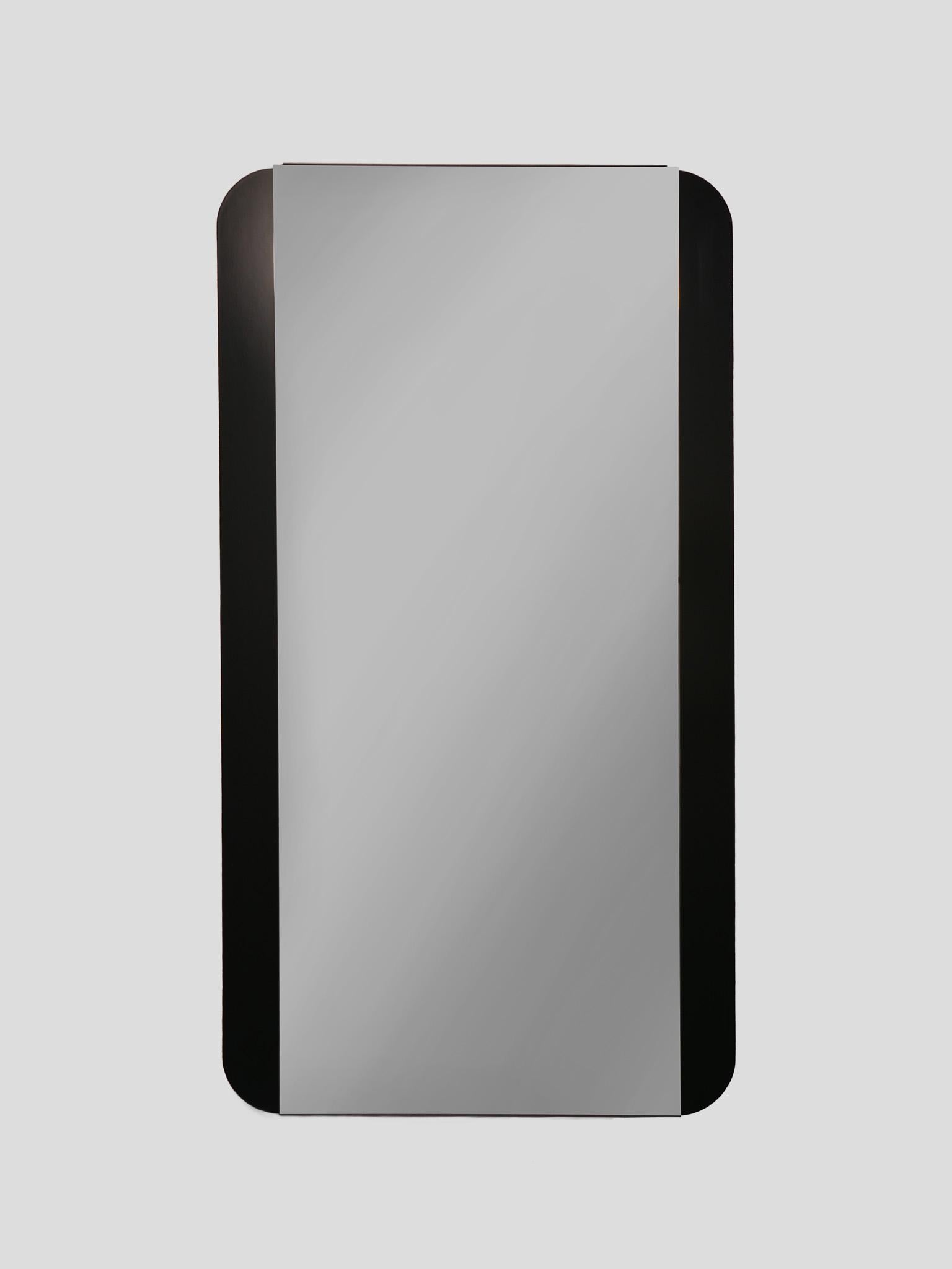Mid-Century Modern Rectangular Black Smoked Wall Mirror, Italy 1970s

The dark wooden beams, the rounded corners and the narrow mirror surface make this beautiful mid-century modern mirror a true eye-catcher. The mirror can be used as a wardrobe