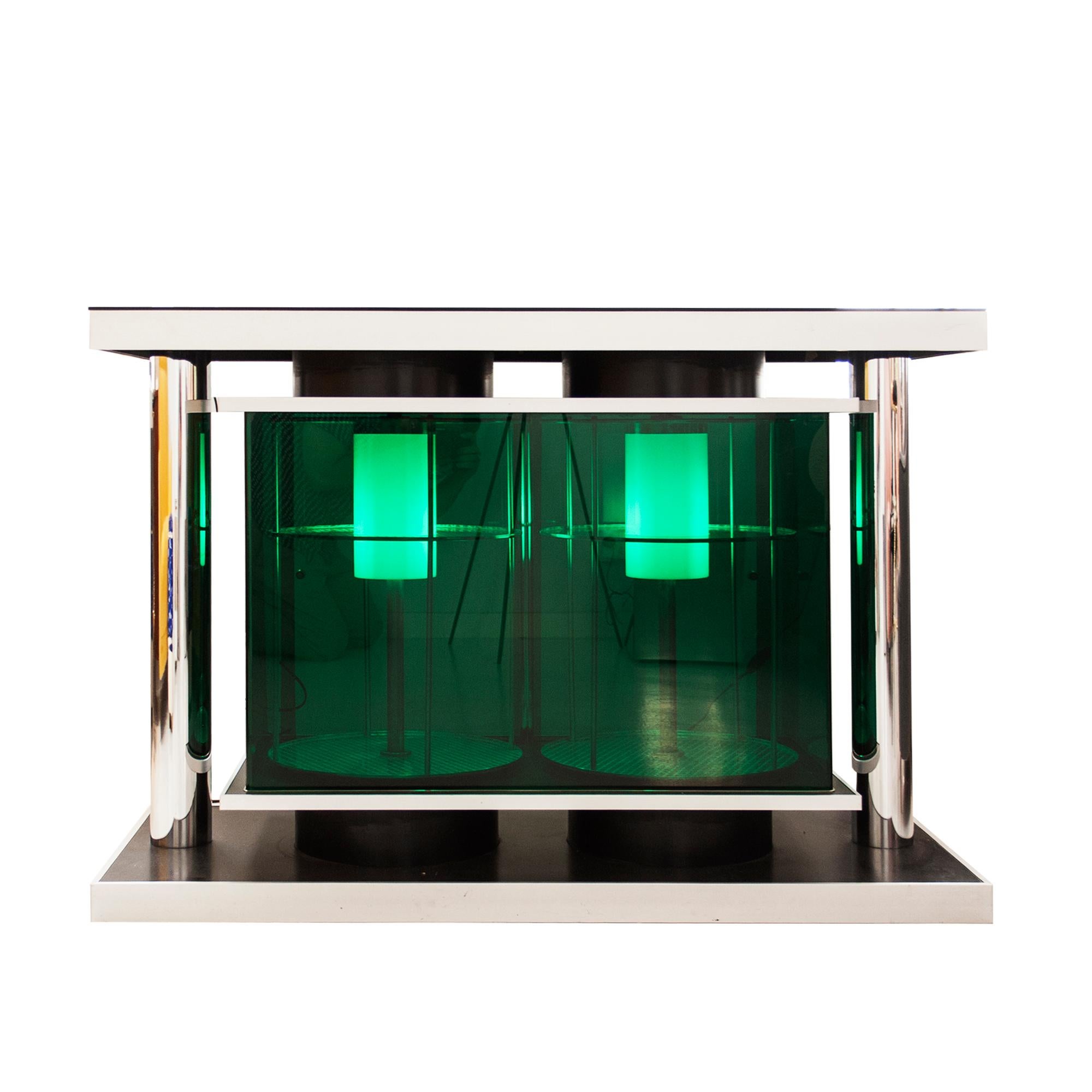 Italian dry bar composed of a wooden structure with perplex green screen and chromed steel details. Interior with revolving bottle rack backlit.