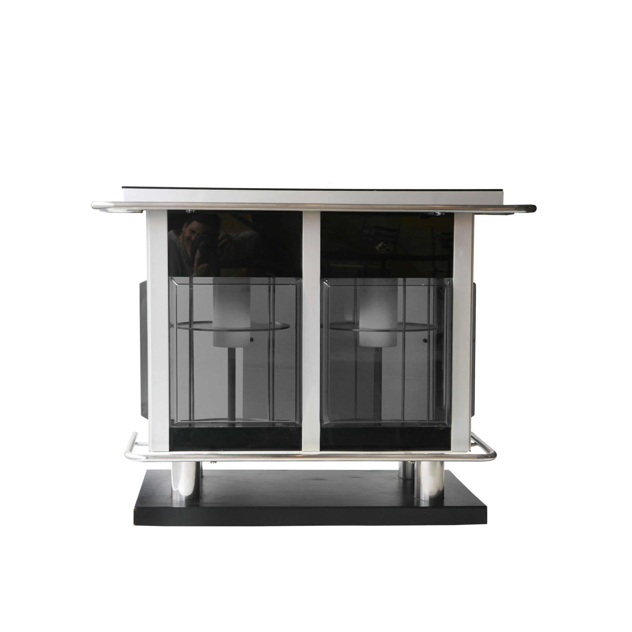 Italian grey bar counter. It consists of a laminated wood structure and base, a semi-transparent gray Perplex shade and chromed steel tube details. The Interior part contains a backlit rotating bottle rack and 2 light sources.
