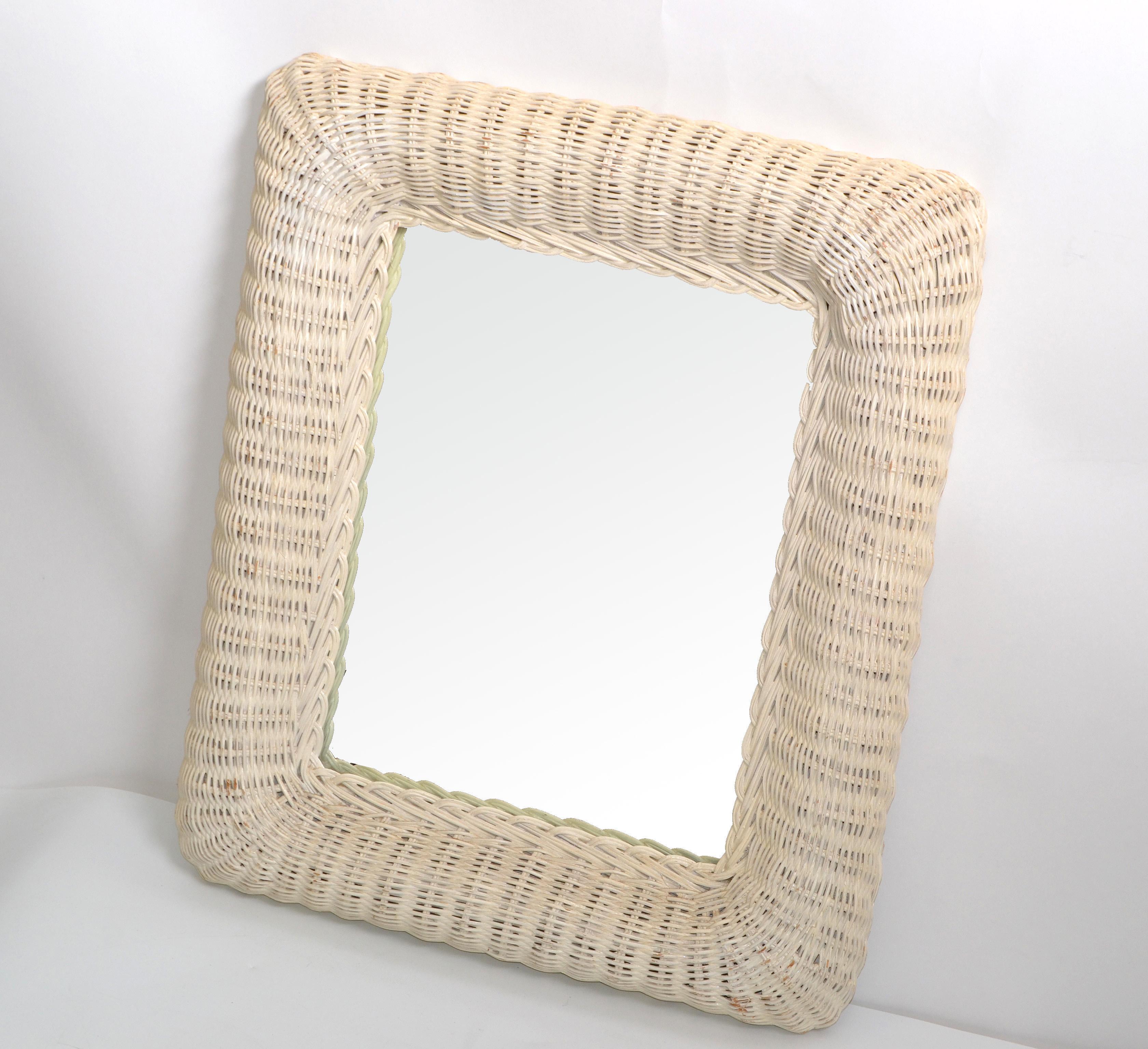 Mid-Century Modern rectangular handmade white finished wicker & wood wall mirror.
The mirror is woven with rattan and has wooden backing.
Mirror size: 10.25 x 13.25 inches.
Bohemian Chic addition for the sunroom.