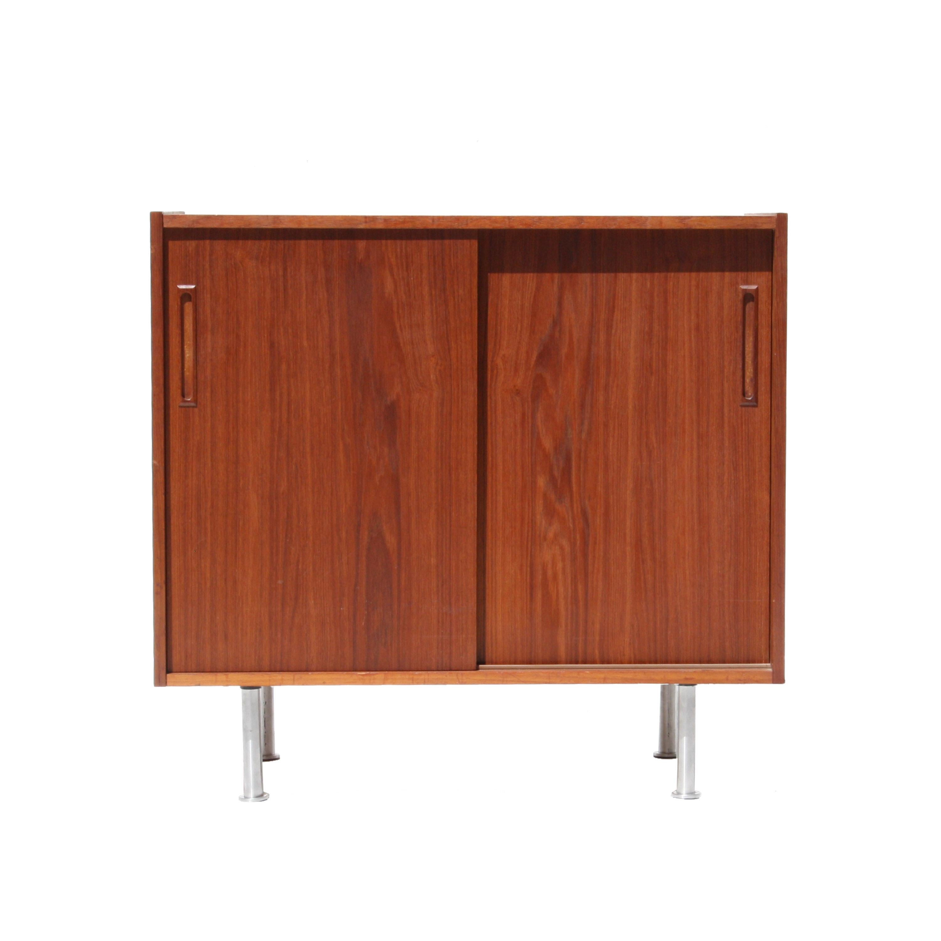 Pair of sideboards made of teak with two sliding doors and rectangular handles. Steel legs.