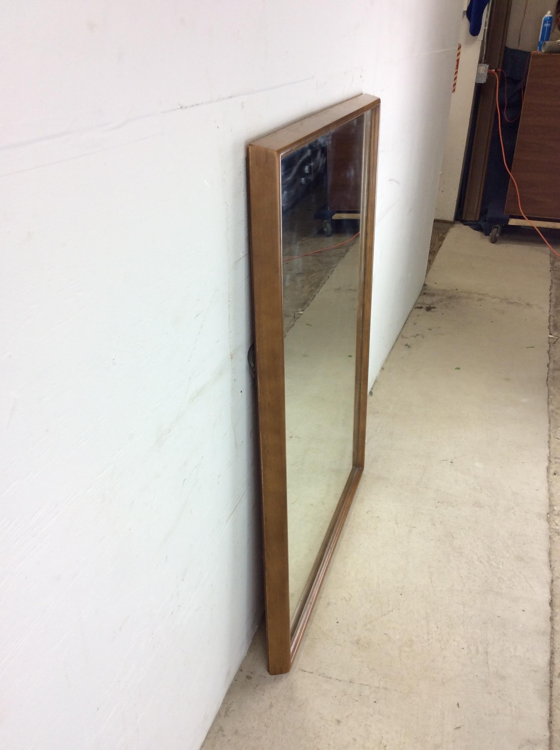 This mid century modern mirror features hardwood frame with unique beveled edge and original walnut finish.

Dimensions: 34w 2.25d 42.5h

Condition: Original finish on frame is in good condition with only minor scuffs, slight scratches, and small