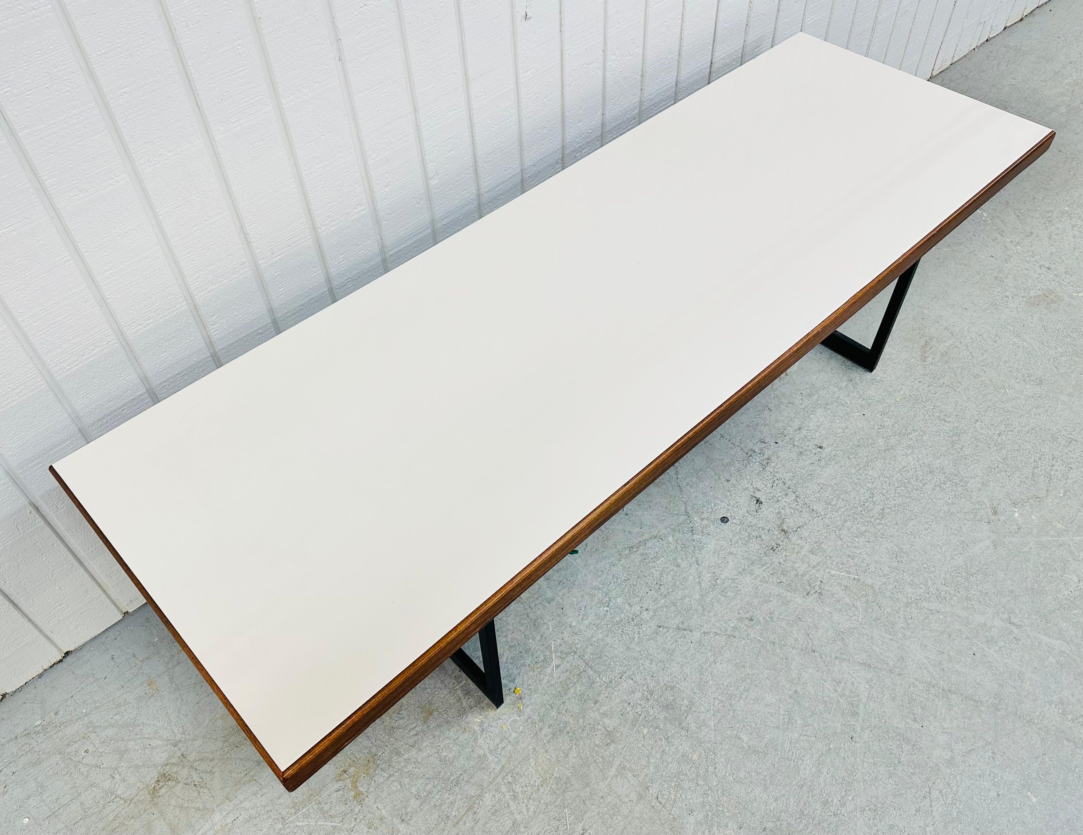 This listing is for a Mid-Century Modern Coffee Table. Featuring a straight line design, rectangular white top, walnut trim, and industrial base.