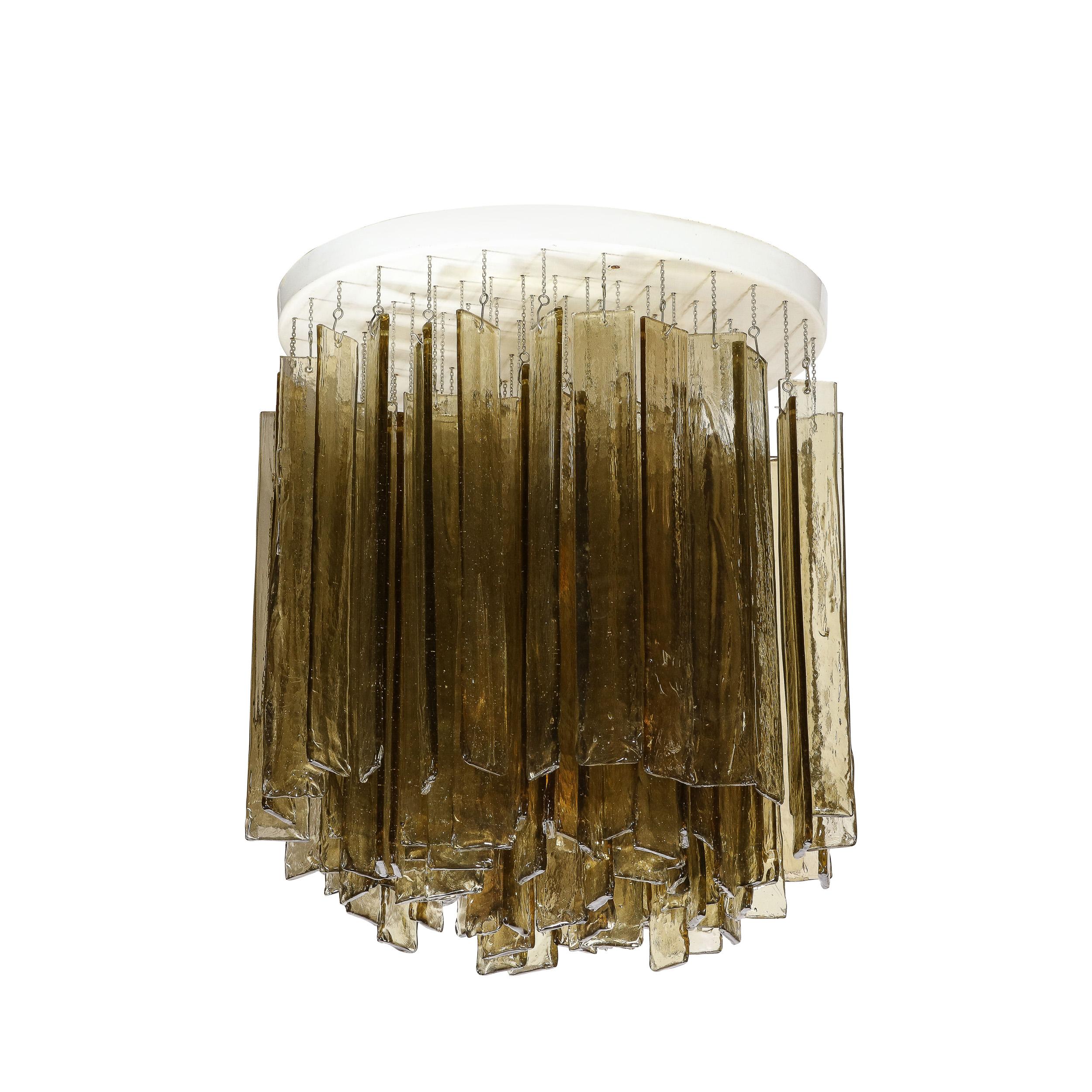 This elegant and refined Mid-Century Modern chandelier was realized by the legendary atelier, Mazzega, in Murano, Italy- the island off the coast of Venice renowned for its superlative glass production- circa 1970. It features an abundance of hand