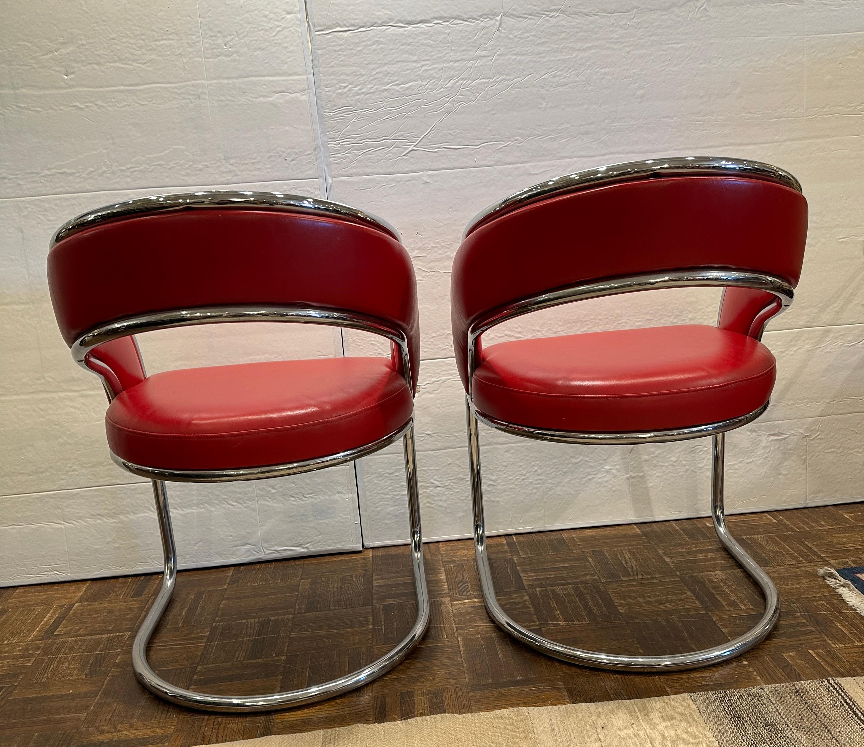 Bright and cheerful pair of red leather and chrome chairs.  Can be used as occasional chairs or game table chairs.  There are another pair on this site if you need another pair.  In great condition.