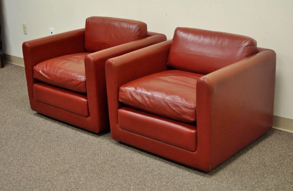 Vintage Mid-Century Modern red leather cube club lounge chairs on casters - a pair. Item features a quality pair of vintage, post-mid-century modern, cube form club chairs in red leather on rolling casters. The chairs features clean lines,