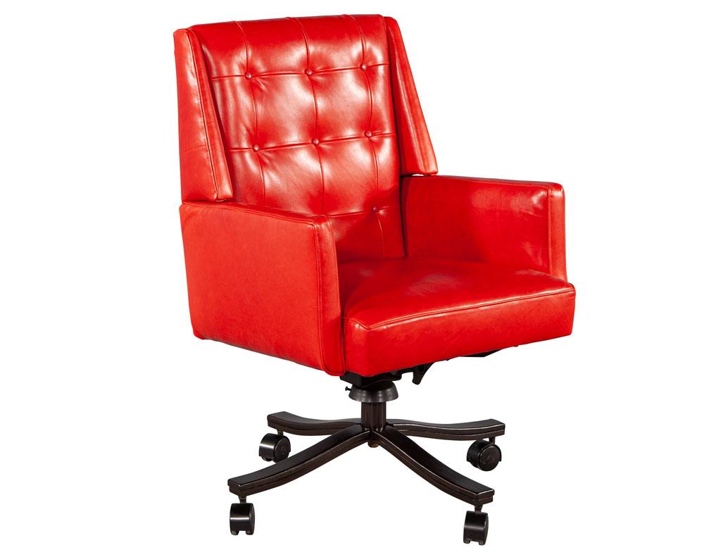 Mid-Century Modern red leather swivel office chair. Iconic Mid-Century Modern office chair design newly upholstered in a red Italian leather with beautiful, tufted back detailing. Frame is composed of wood in a rich espresso color finish. Chair has