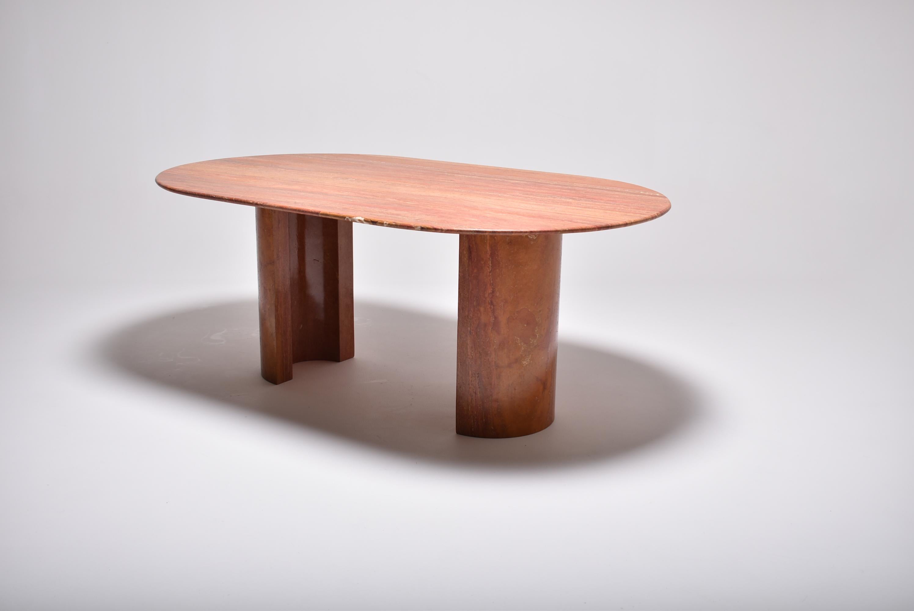 Midcentury oval dining table, made in Italy during the 1970s, in Red Persian Travertine.
Practical and inviting, it can sit eight guests comfortably. The two half circle legs leave all needed room.
The table top had a new polishing, revealing the