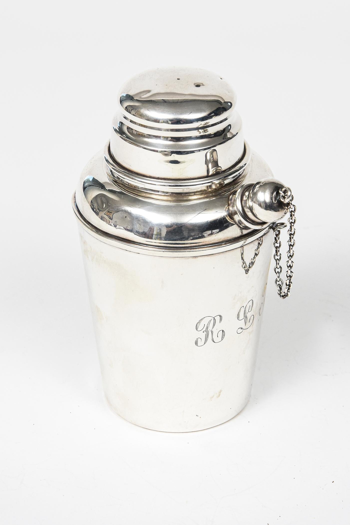 Fabulous Reed & Barton sterling mini martini shaker for making an individual martini. A tapered cylinder design with removable lift-up dome lid, pronounced spout with stopper on chain. The shaker is engraved on the bottom and has RLT initials in