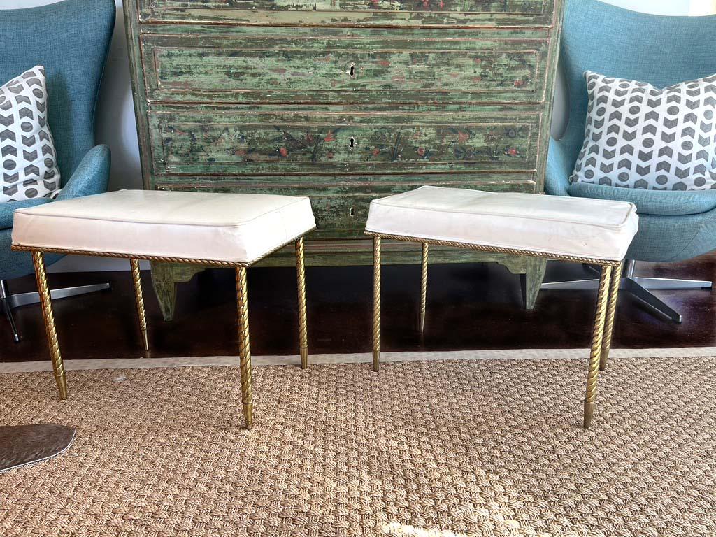 A pair of beautiful regency style benches with a rope design by Charles Hollis Jones. The original tag is intact. The stools are upholstered in the original white Naugahyde and can be used but are in need of new upholstery. Excellent original