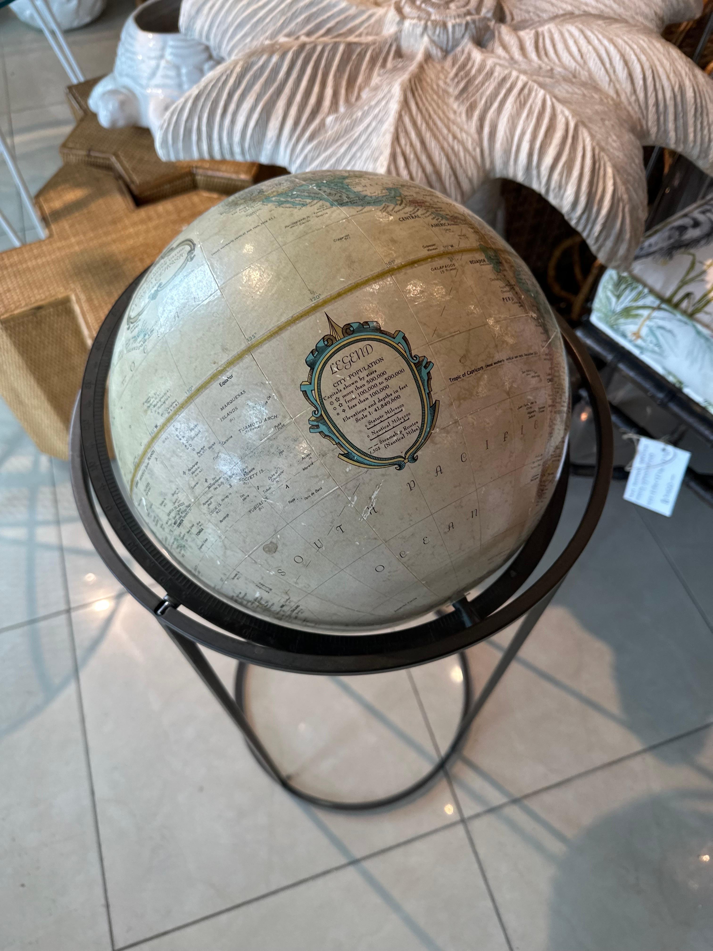 1950's era Paul McCobb style globe with patina brass stand. Brass is original and has not been polished. Globe does have age, pictured. Dimensions: 34.5 H x 14.5 D. 