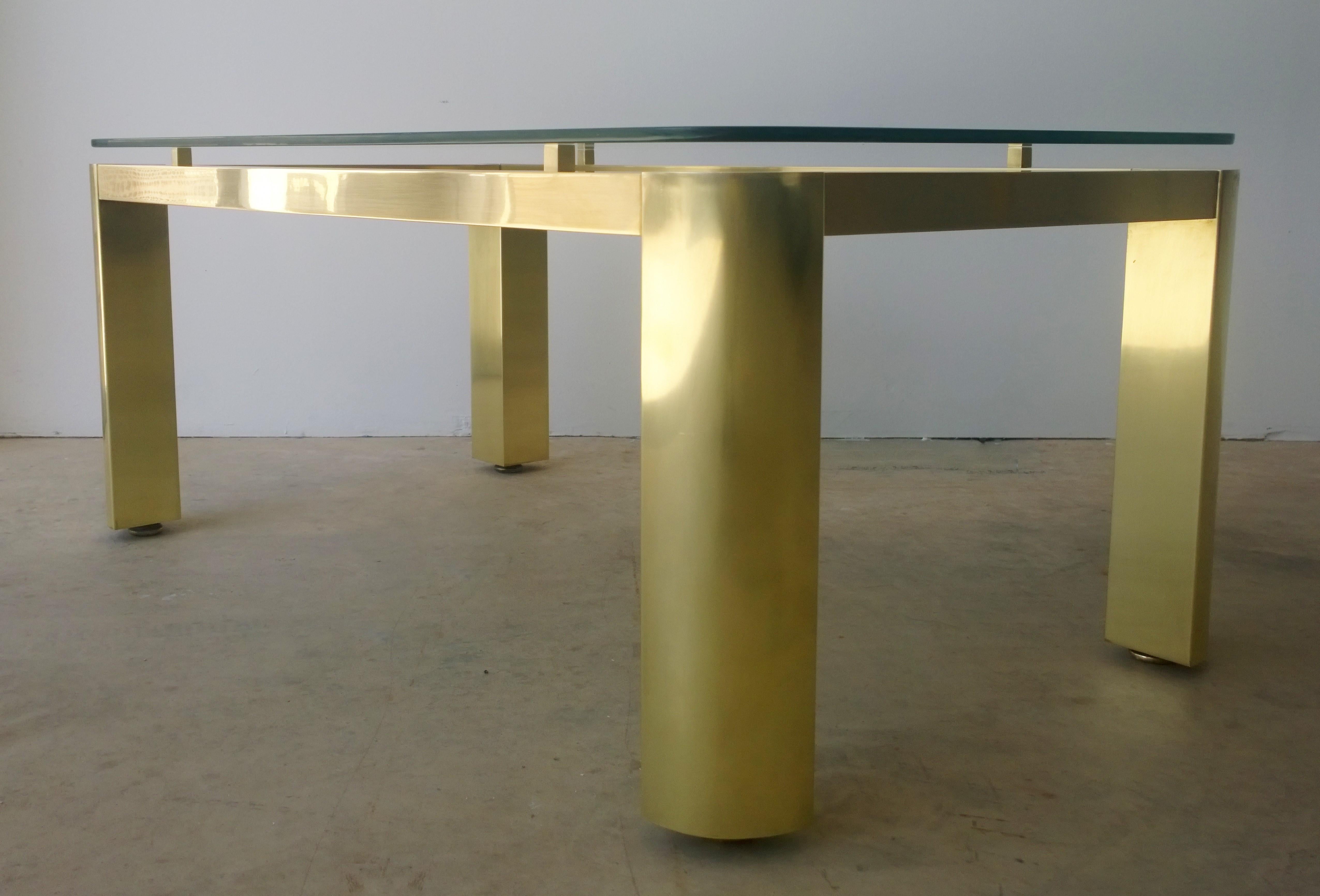 Offered is a Mid-Century Modern fully restored Pace brass, rounded edge floating glass and adjustable feet rectangular cocktail or coffee table. This substantial lacquered shiny brass coffee table with clean and modern design lines is highlighted by