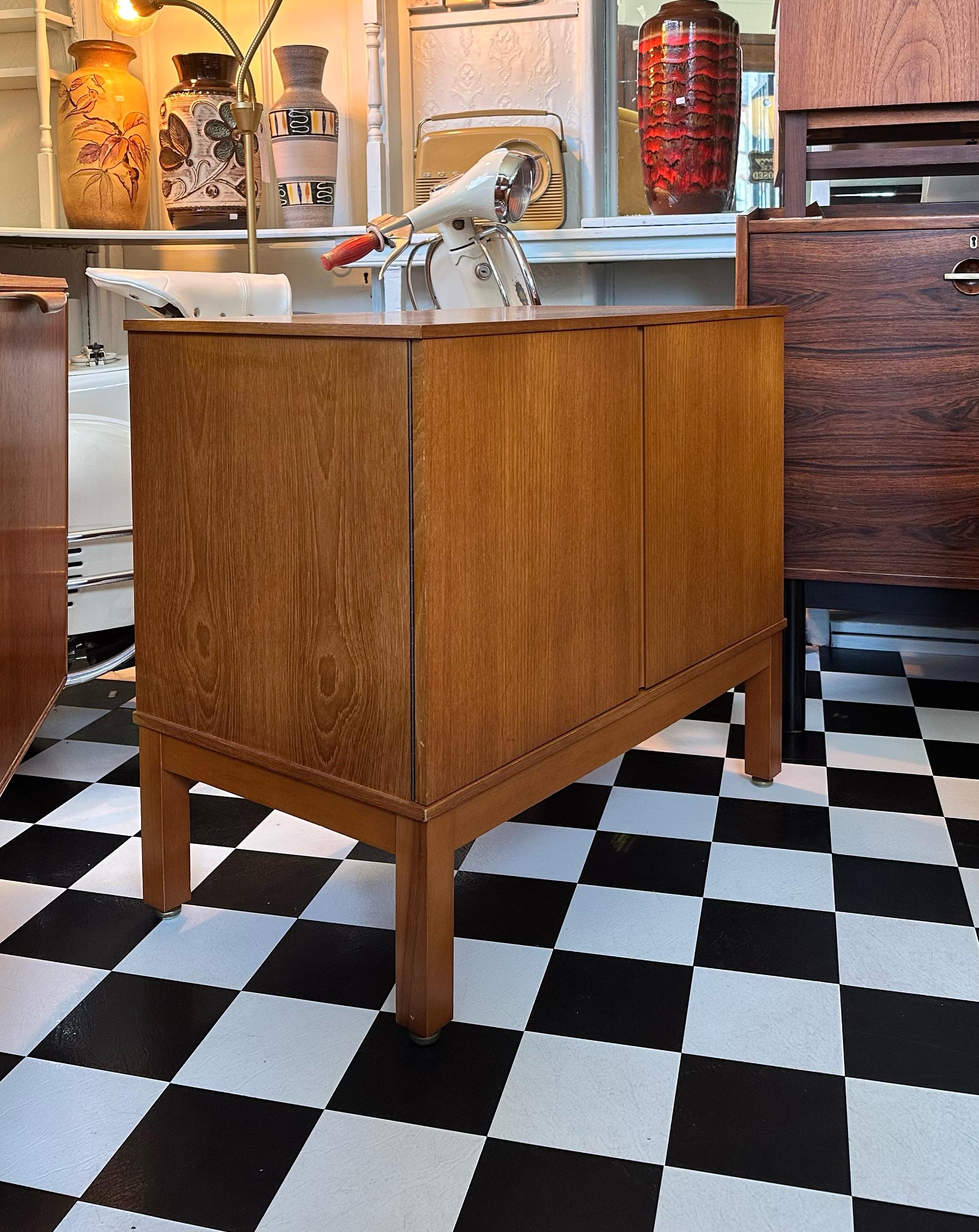 Stunning mid century modern vinyl / media / record cabinet.
Golden teak finish, with stylish legs and sleek doors, which reveal sliding shelf and four storage compartments.
Beautiful compact piece which offers plenty of storage.
This would make a
