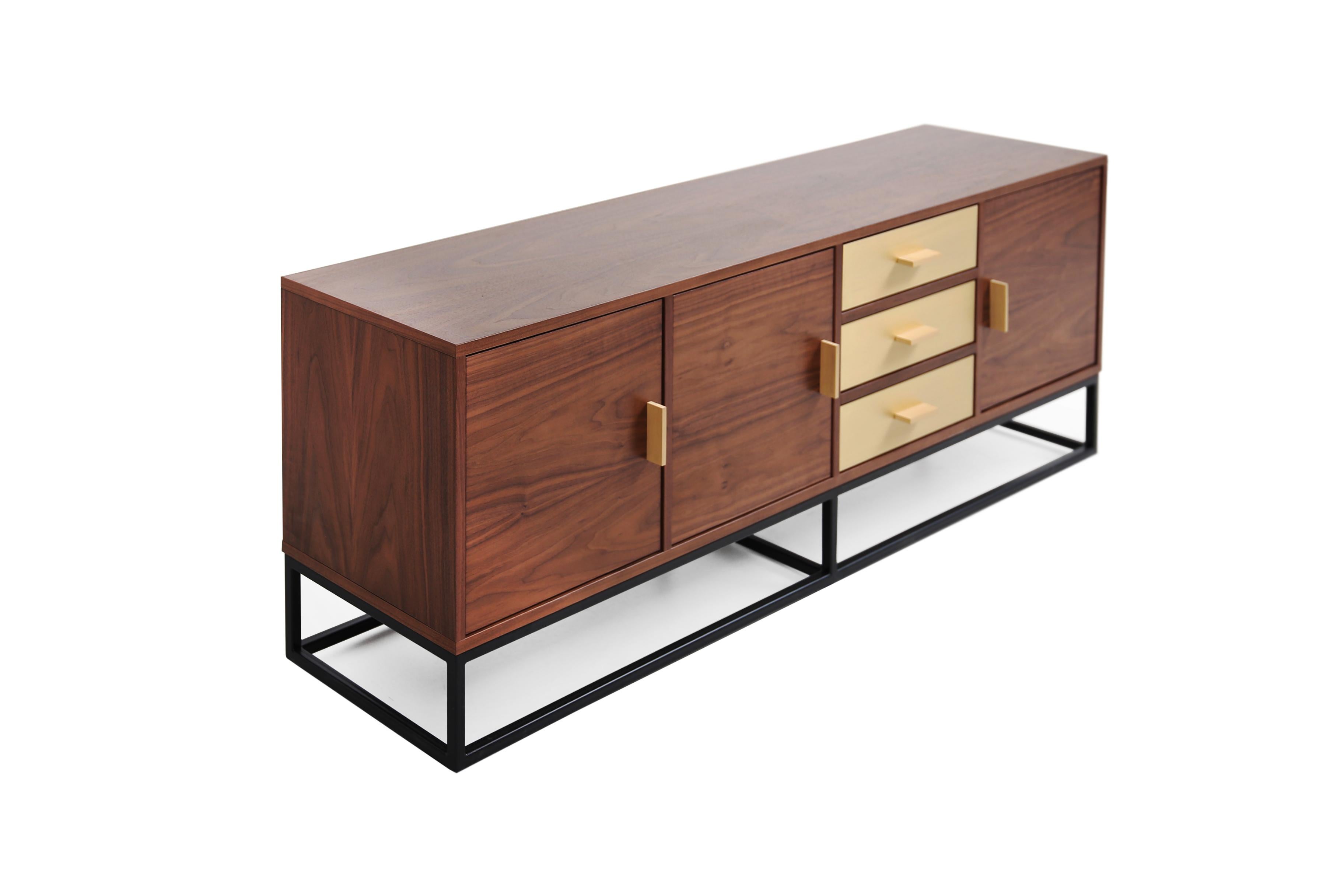 Introducing the perfect blend of timeless elegance and practicality - our stunning sideboard Reykjavik with a midcentury feel. Crafted from premium walnut veneers, brushed brass and black steel legs, this piece is a true statement of sophistication