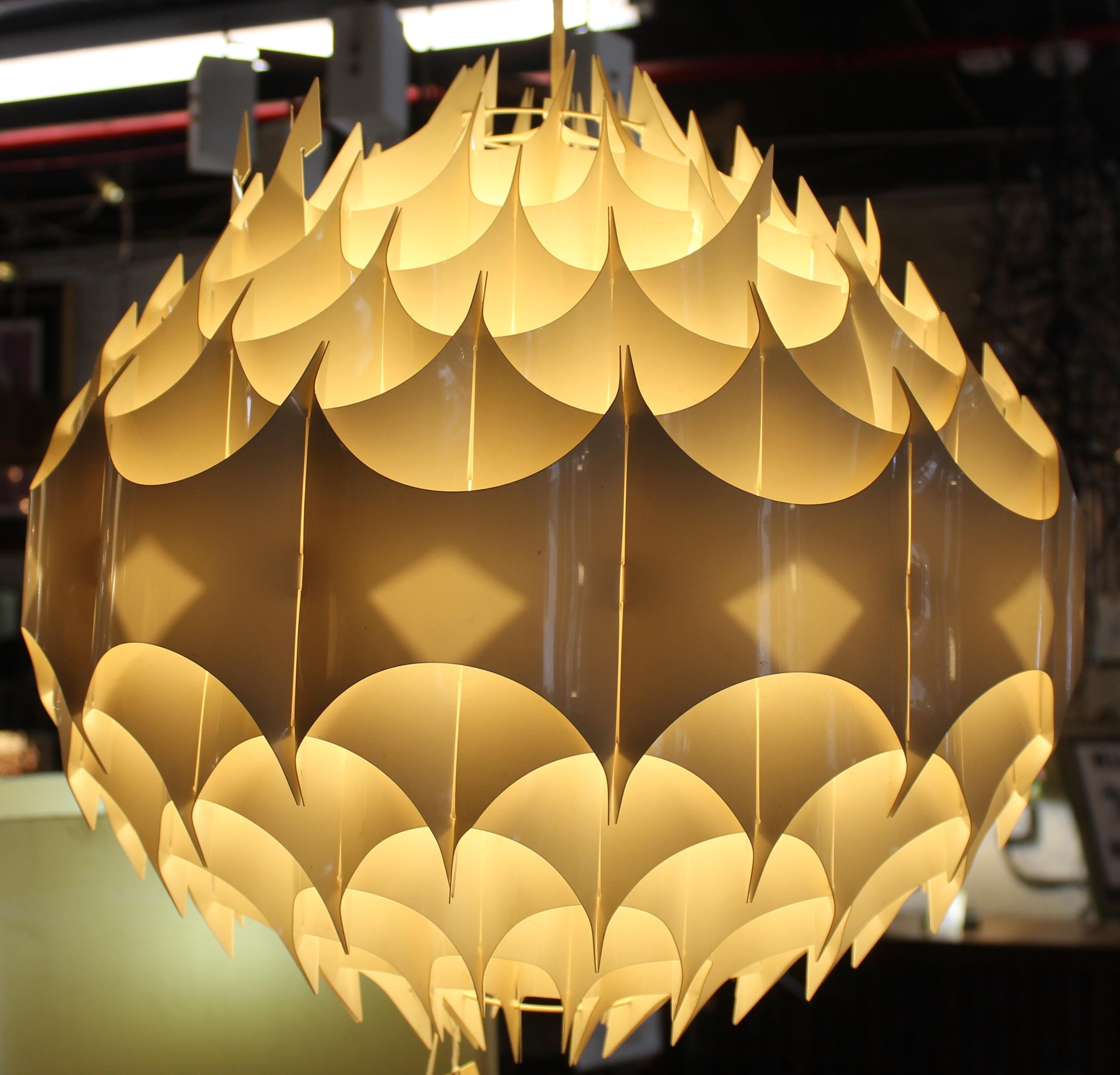 Striking and rare 'Rhythmik' pendant light designed by Milanda Havlova for VEST, Austria. This sculptural fixture features a dynamic, rhythmic design in molded acrylic with layered geometric forms that diffuse light beautifully. A standout example